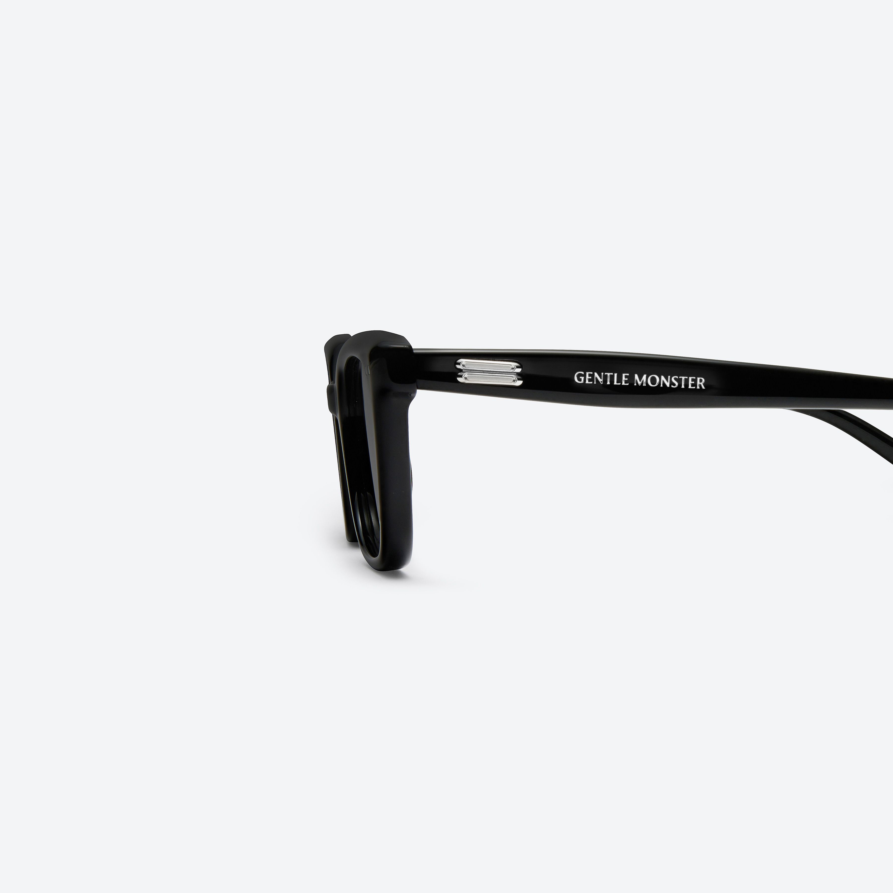 A detailed left view of Gentle Monster Soho.s 01 Black Acetate framed Square sunglasses.