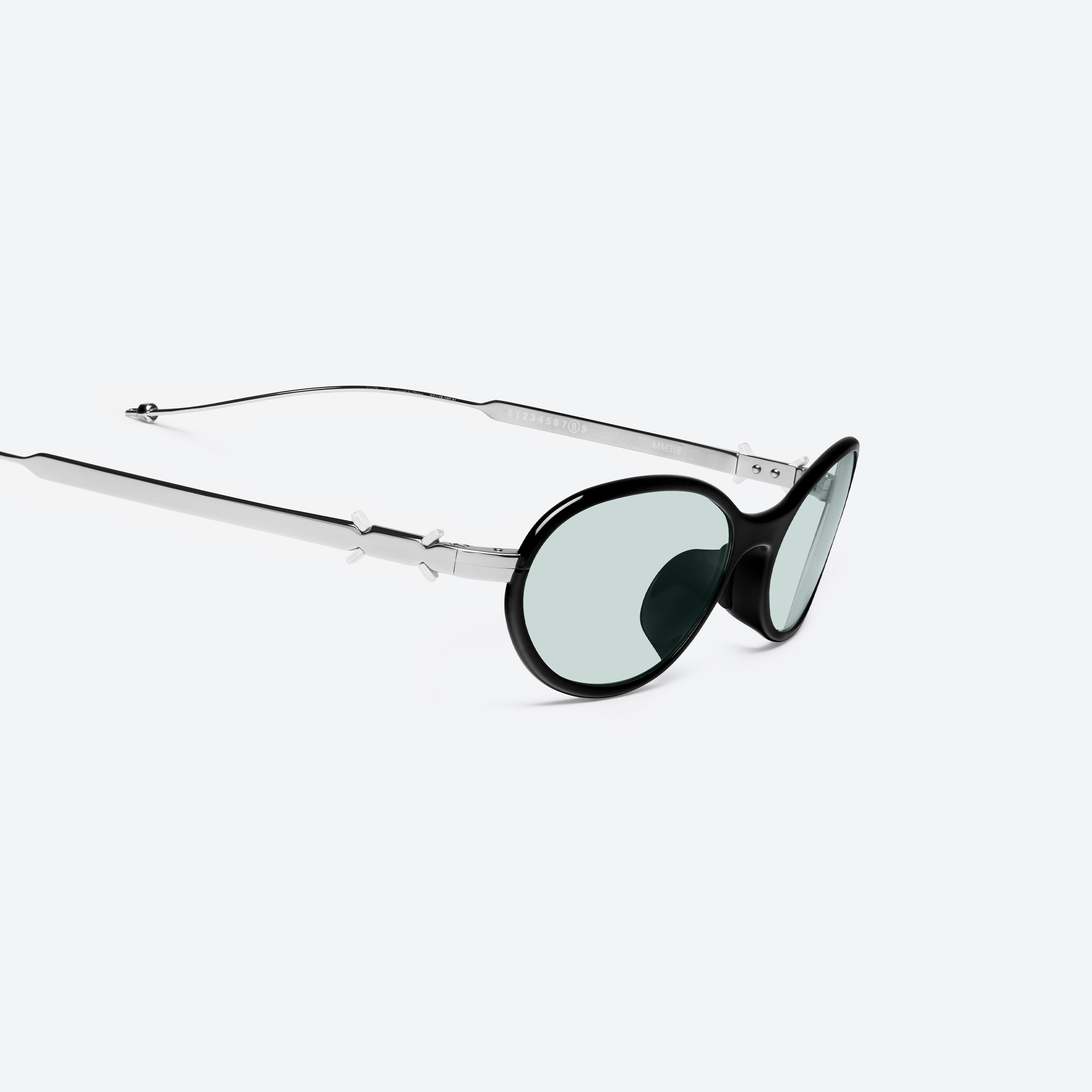 45-degree detailed view of Gentle Monster Maison Margiela - MM318 01 Black Metal framed Oval sunglasses.