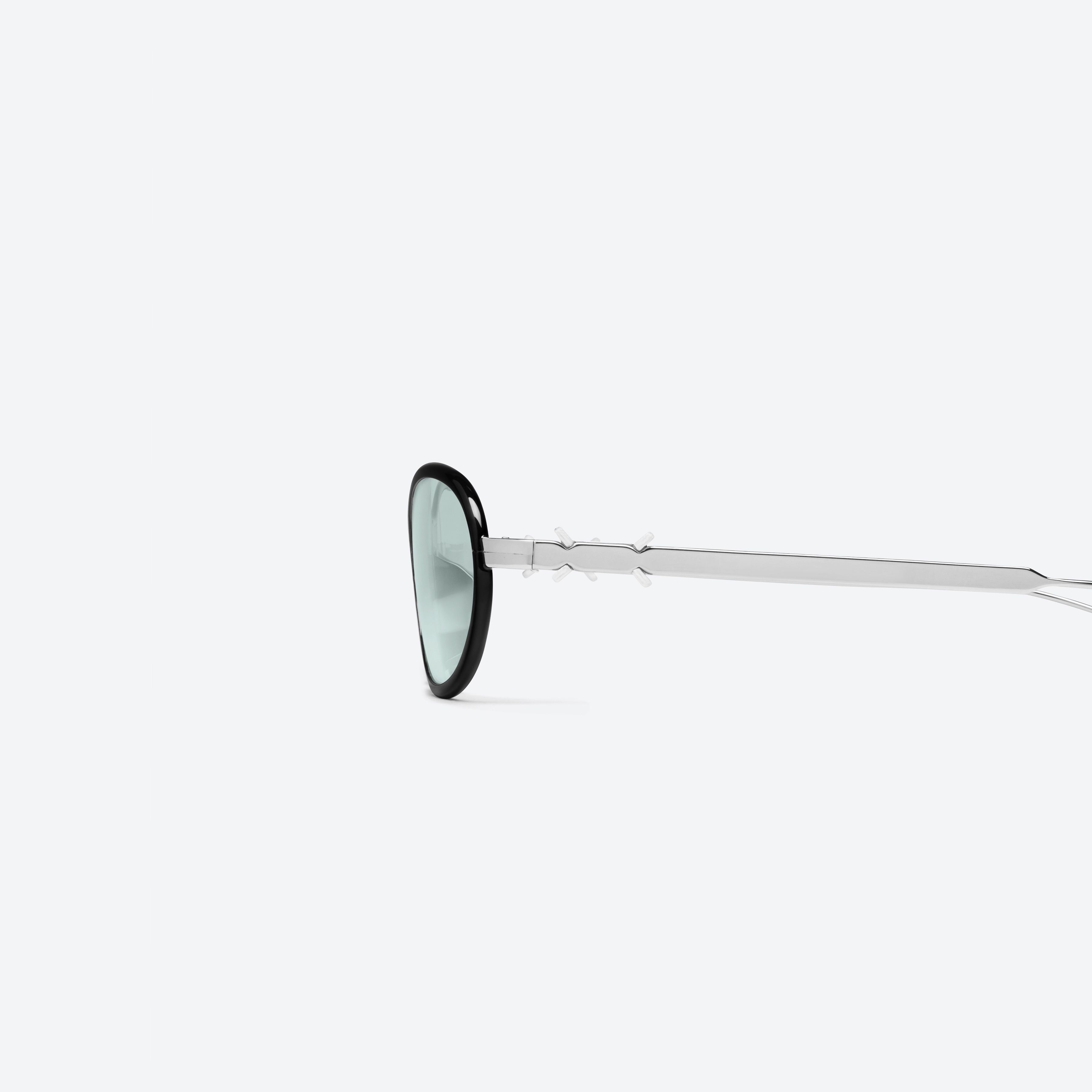 A detailed left view of Gentle Monster Maison Margiela - MM318 01 Black Metal framed Oval sunglasses.