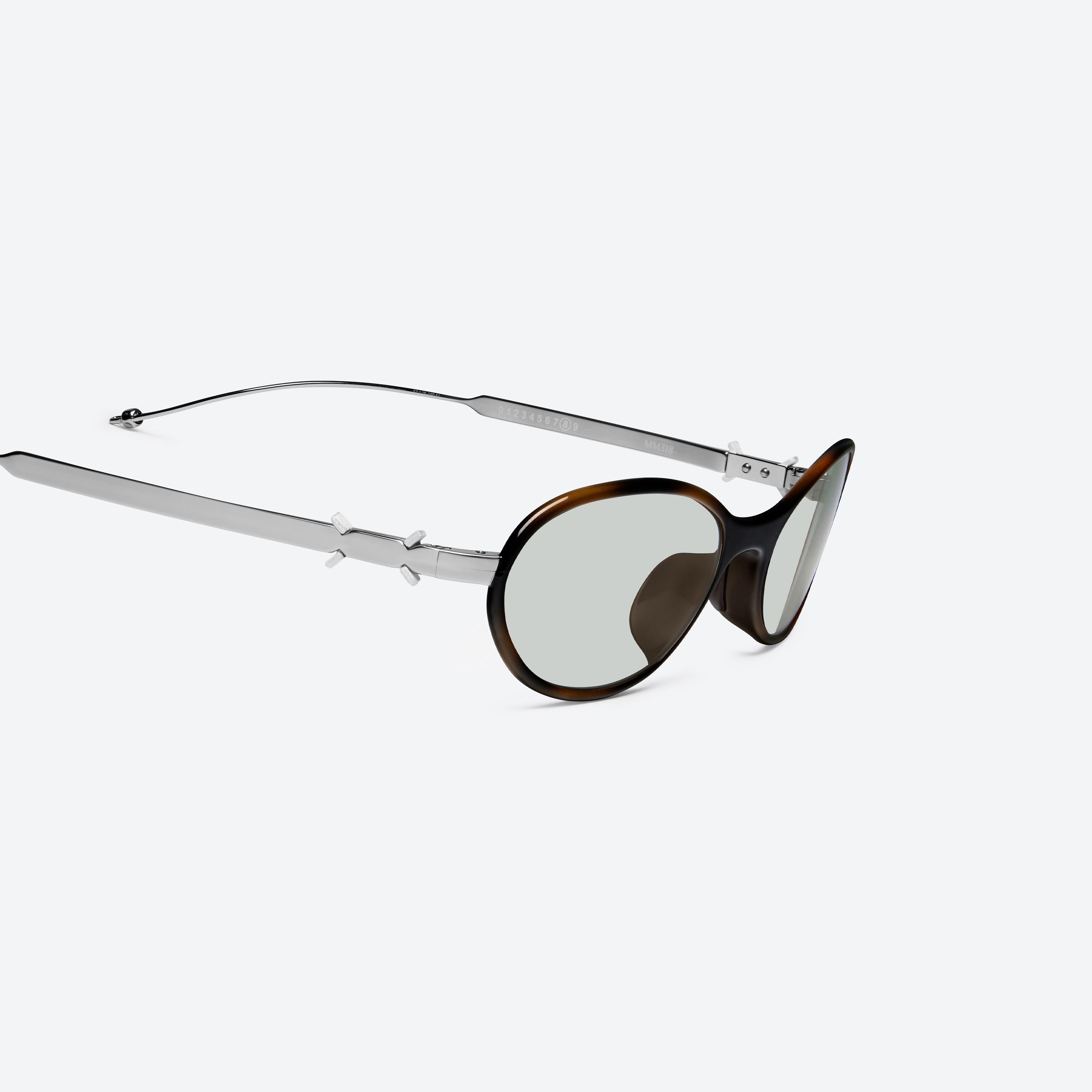 45-degree detailed view of Gentle Monster Maison Margiela - MM318 L2 Brown Metal framed Oval sunglasses.