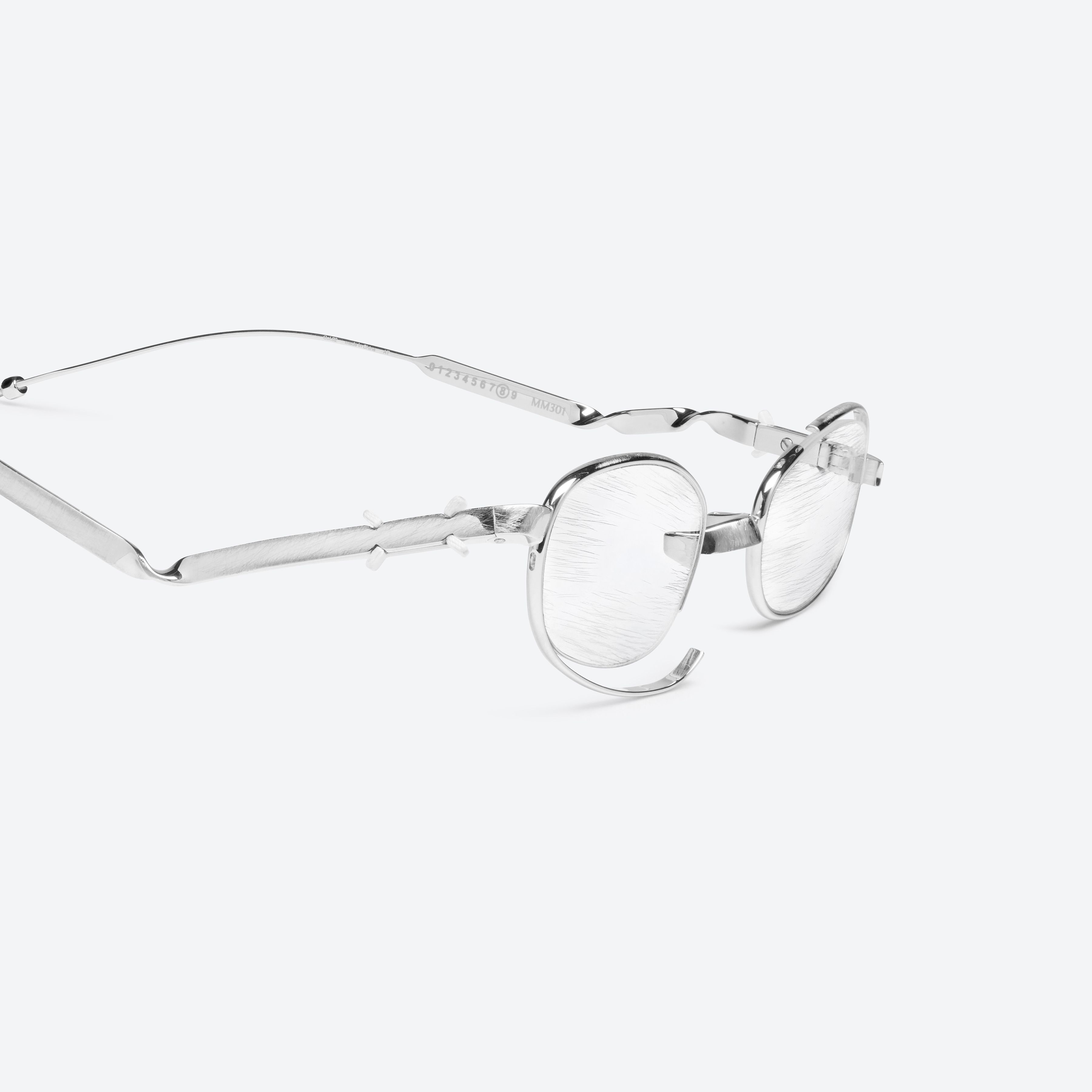 45-degree detailed view of Gentle Monster Maison Margiela - MM301 02 Silver Metal framed Oval glasses.