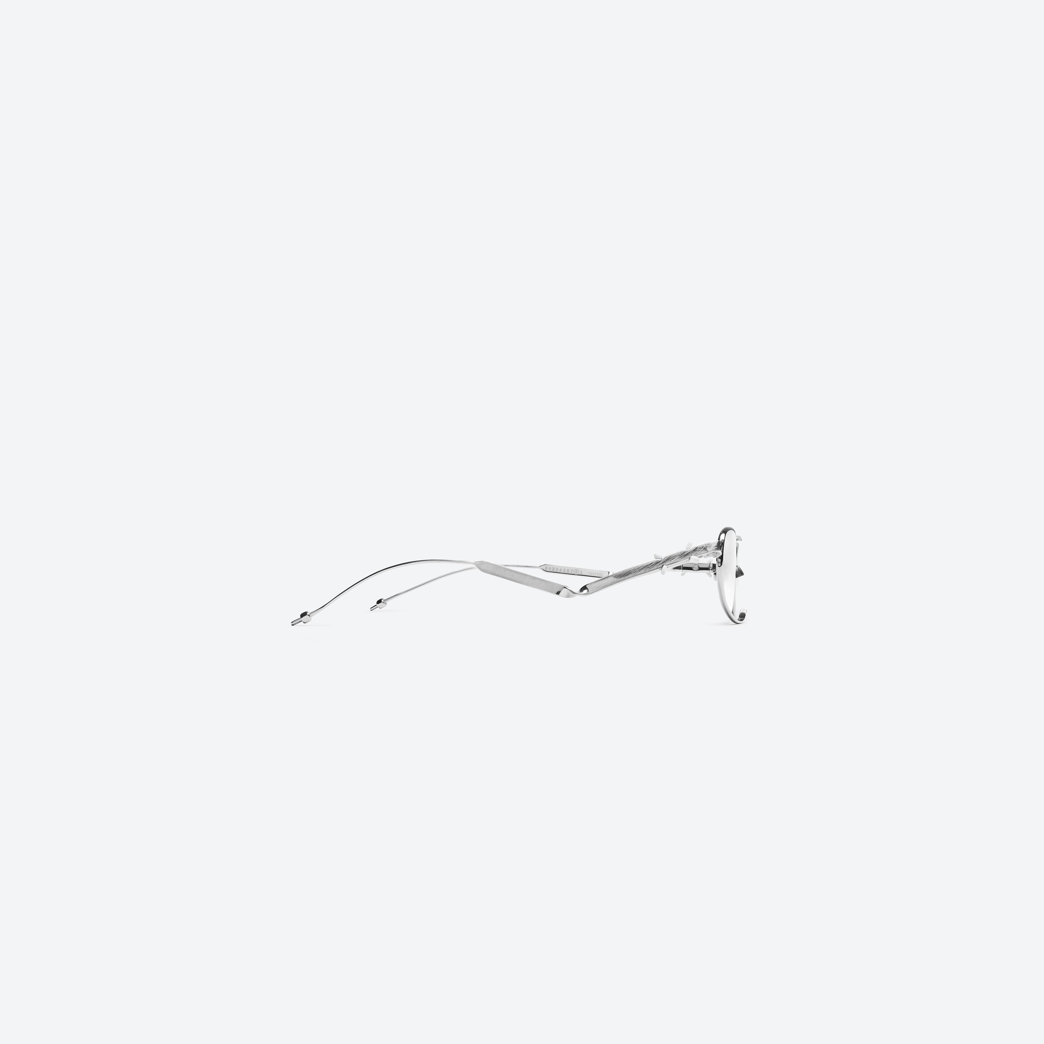 A detailed right view of Gentle Monster Maison Margiela - MM301 02 Silver Metal framed Oval glasses.