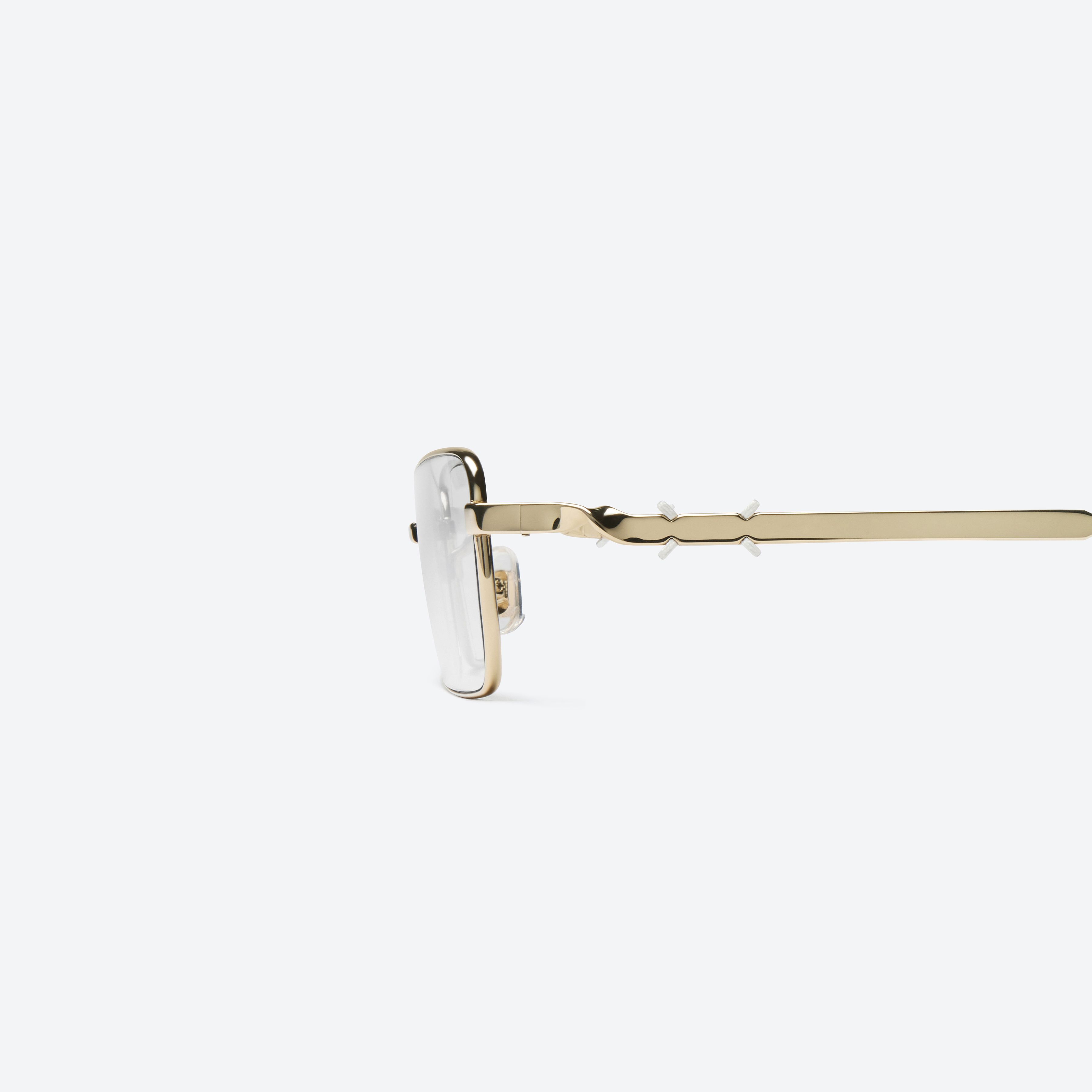 A detailed left view of Gentle Monster Maison Margiela - MM302 039 Gold Metal framed Square glasses.
