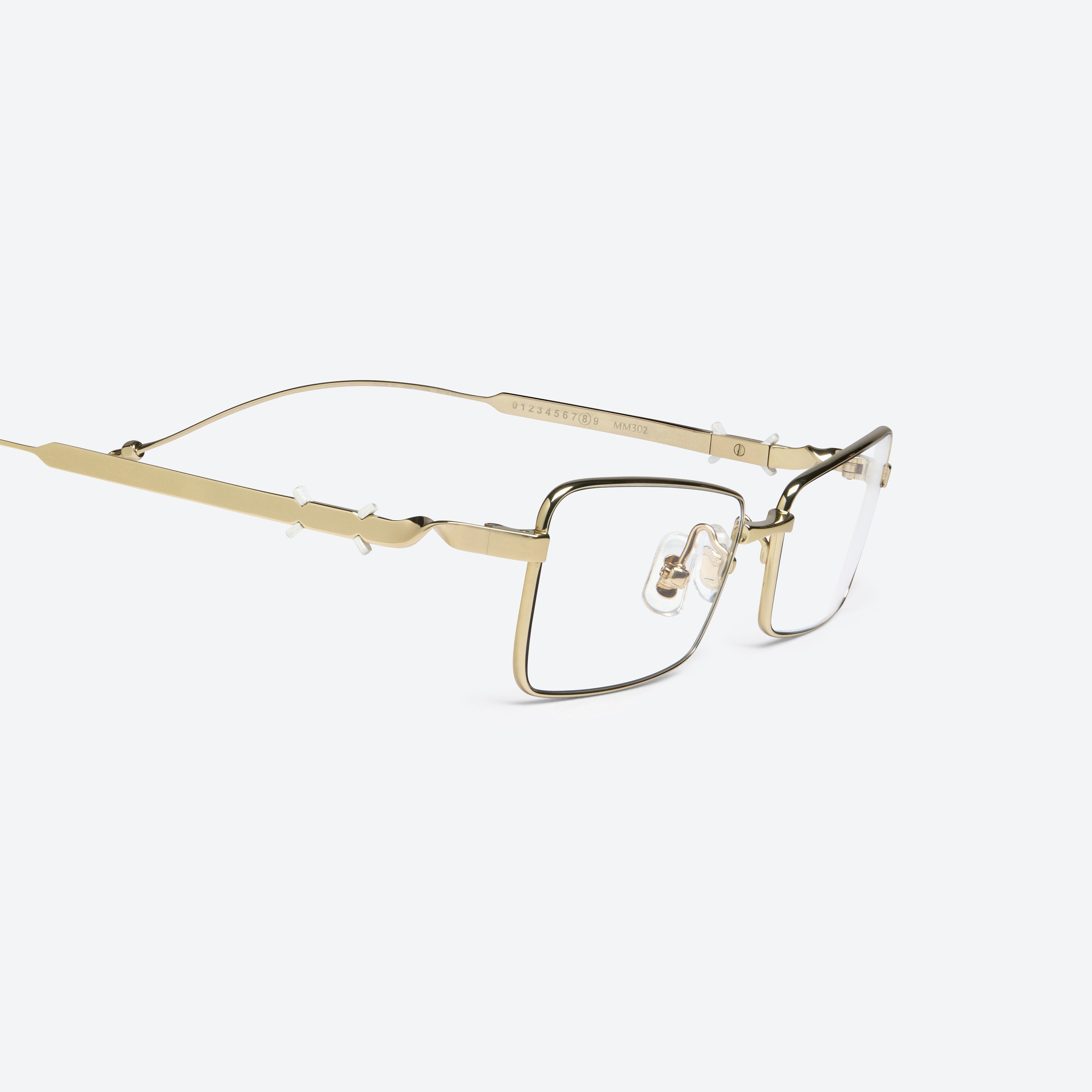 45-degree detailed view of Gentle Monster Maison Margiela - MM302 039 Gold Metal framed Square glasses.