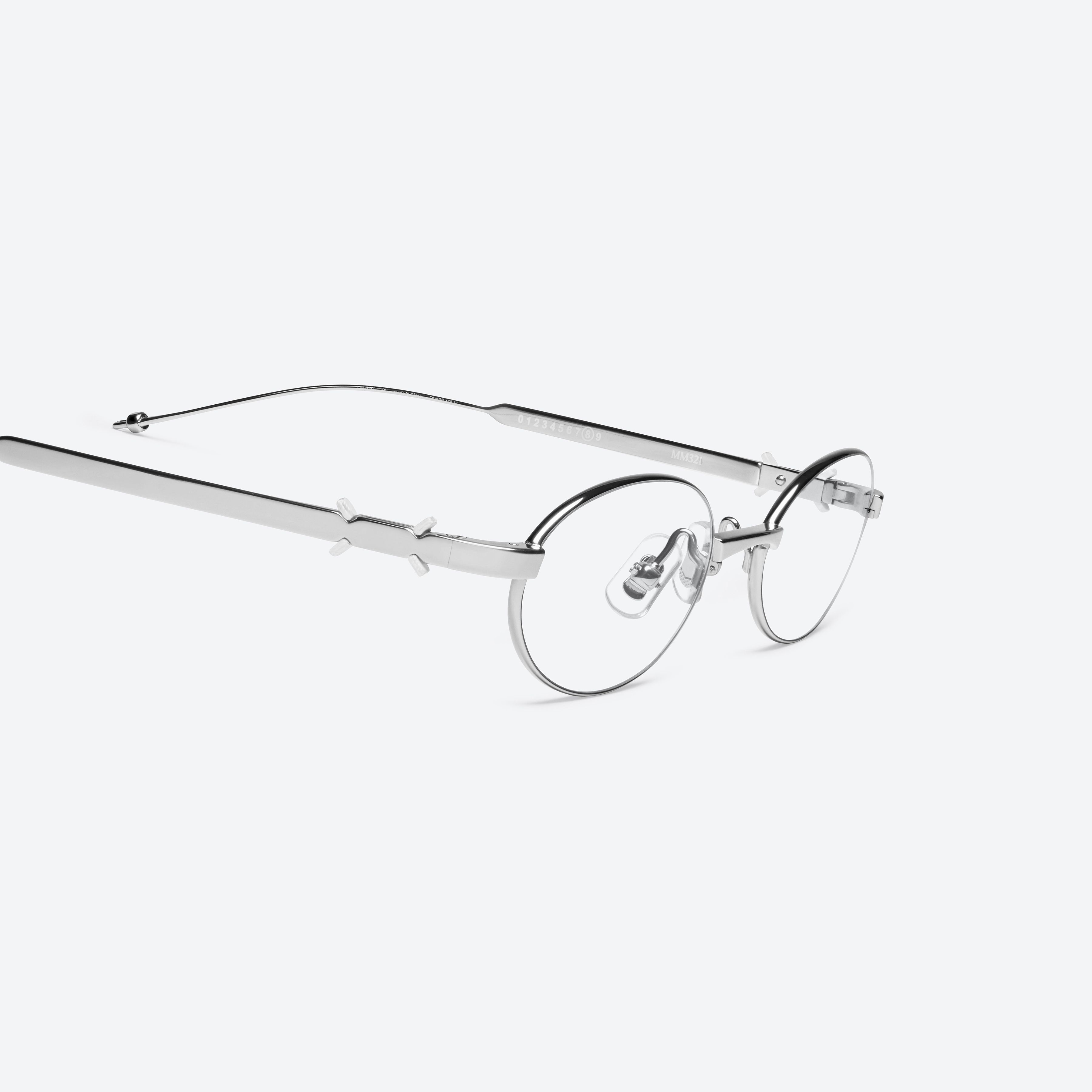 45-degree detailed view of Gentle Monster Maison Margiela - MM321 02 Silver Metal framed Oval glasses.