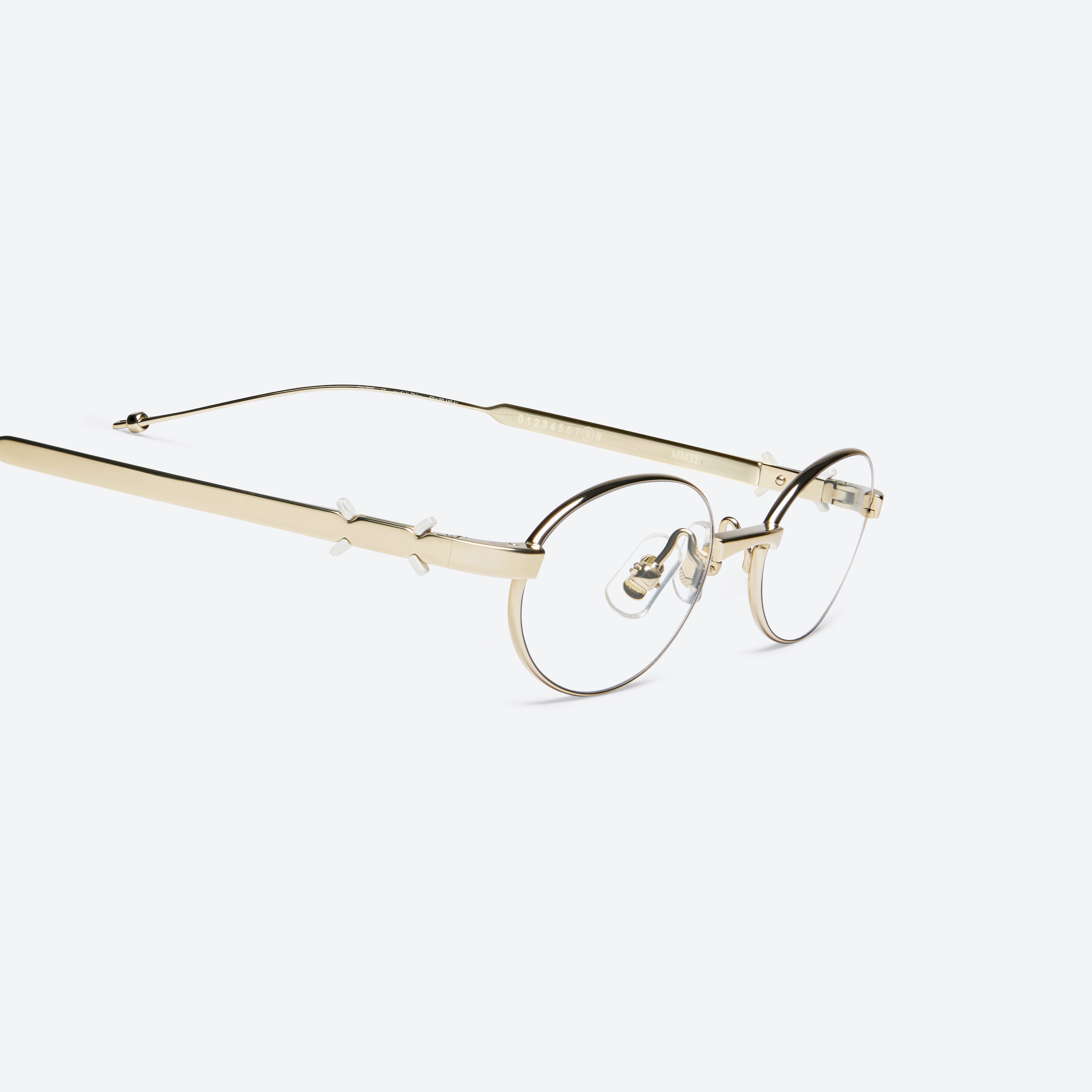 45-degree detailed view of Gentle Monster Maison Margiela - MM321 039 Gold Metal framed Oval glasses.