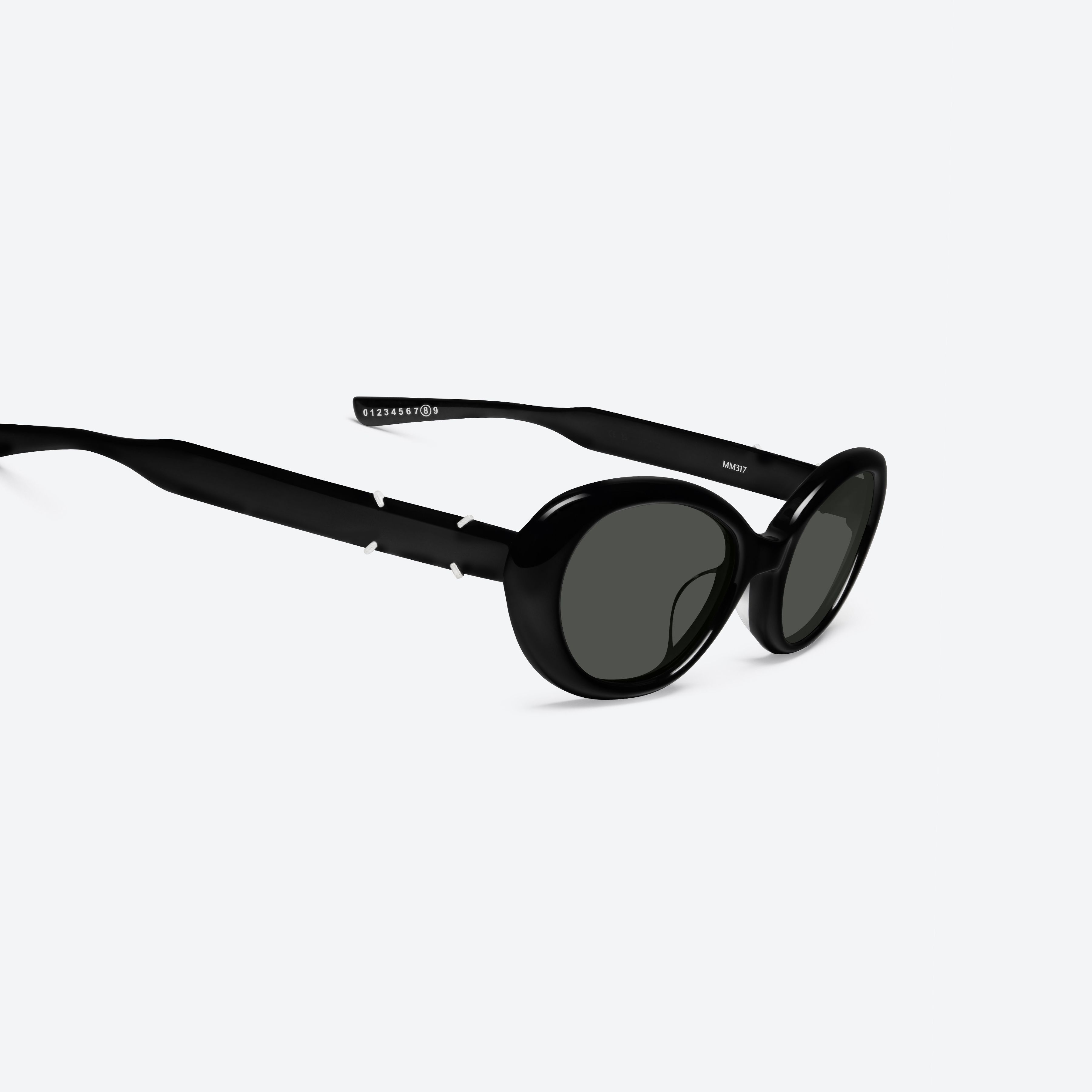45-degree detailed view of Gentle Monster Maison Margiela - MM317 01 Black Acetate framed Oval sunglasses.