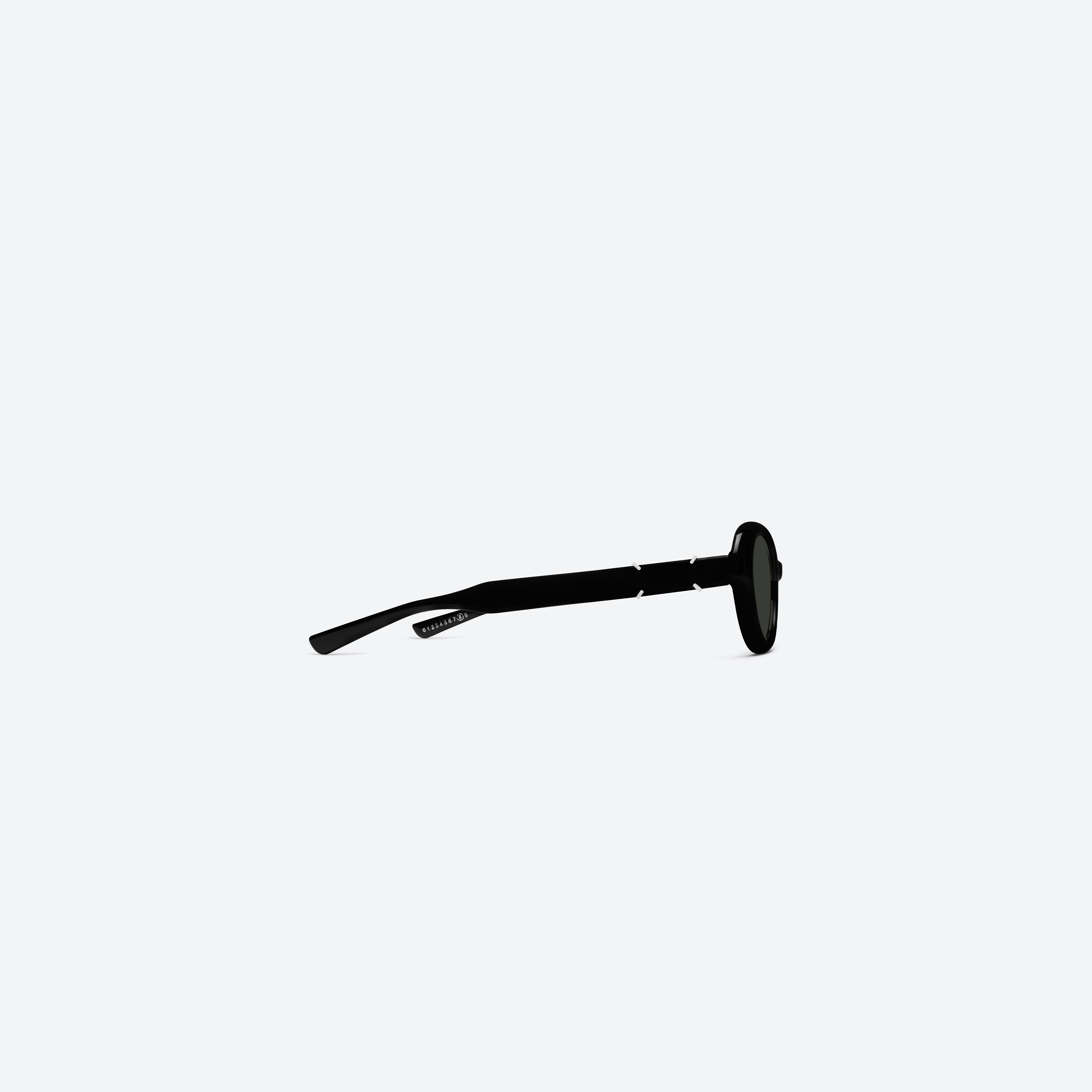 A detailed right view of Gentle Monster Maison Margiela - MM317 01 Black Acetate framed Oval sunglasses.