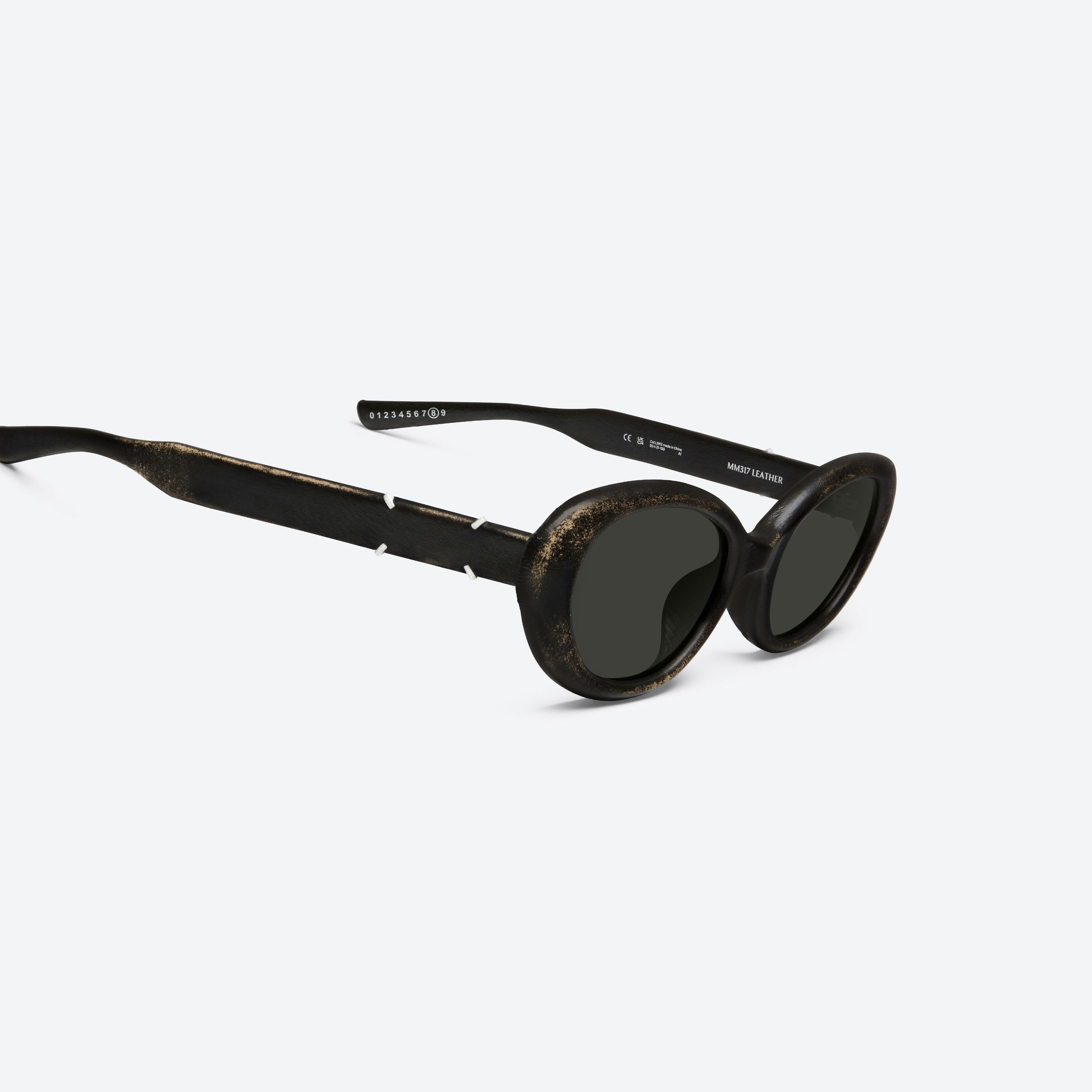 45-degree detailed view of Gentle Monster Maison Margiela - MM317 Leather LBK2 Similar Black Acetate framed Oval sunglasses.