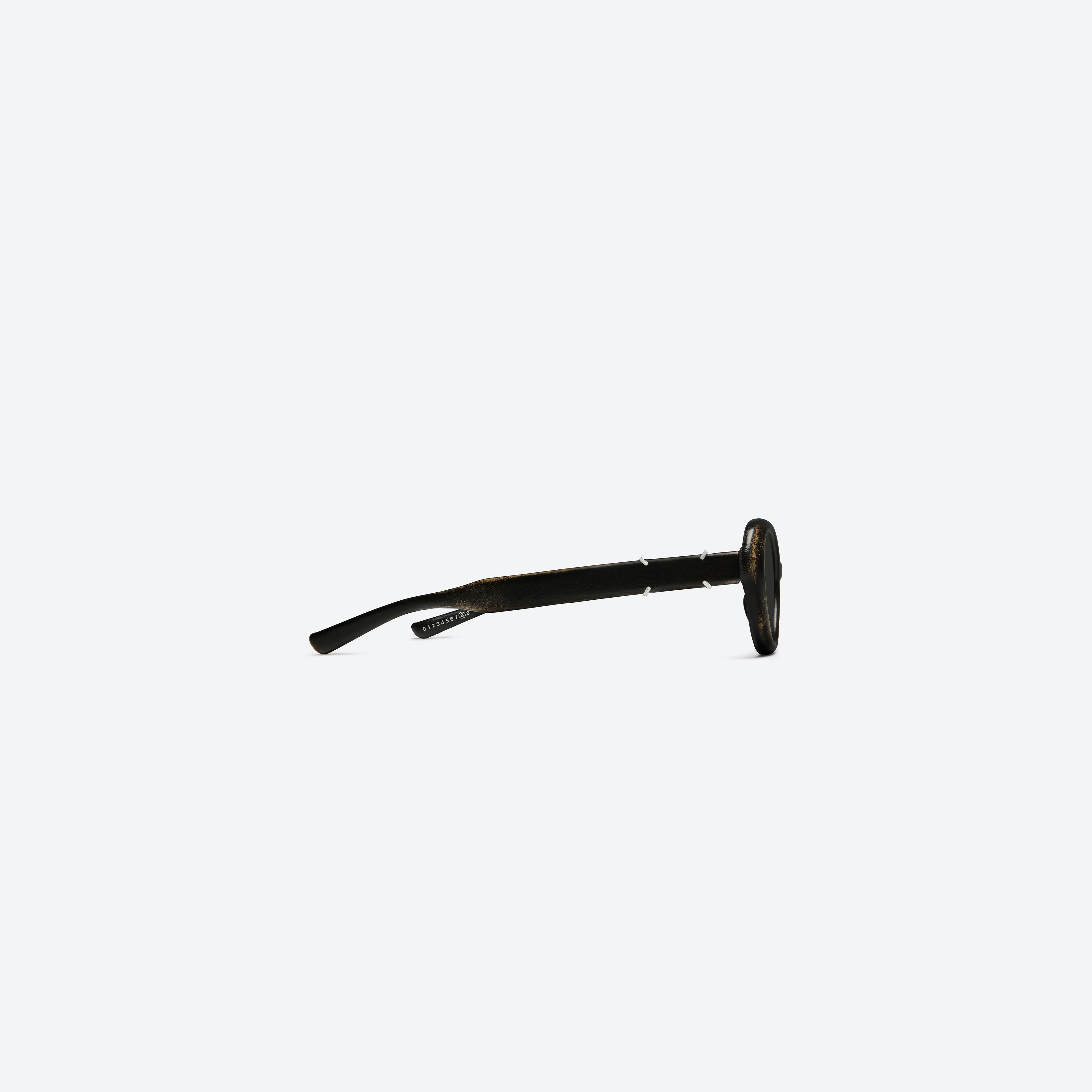 A detailed right view of Gentle Monster Maison Margiela - MM317 Leather LBK2 Similar Black Acetate framed Oval sunglasses.