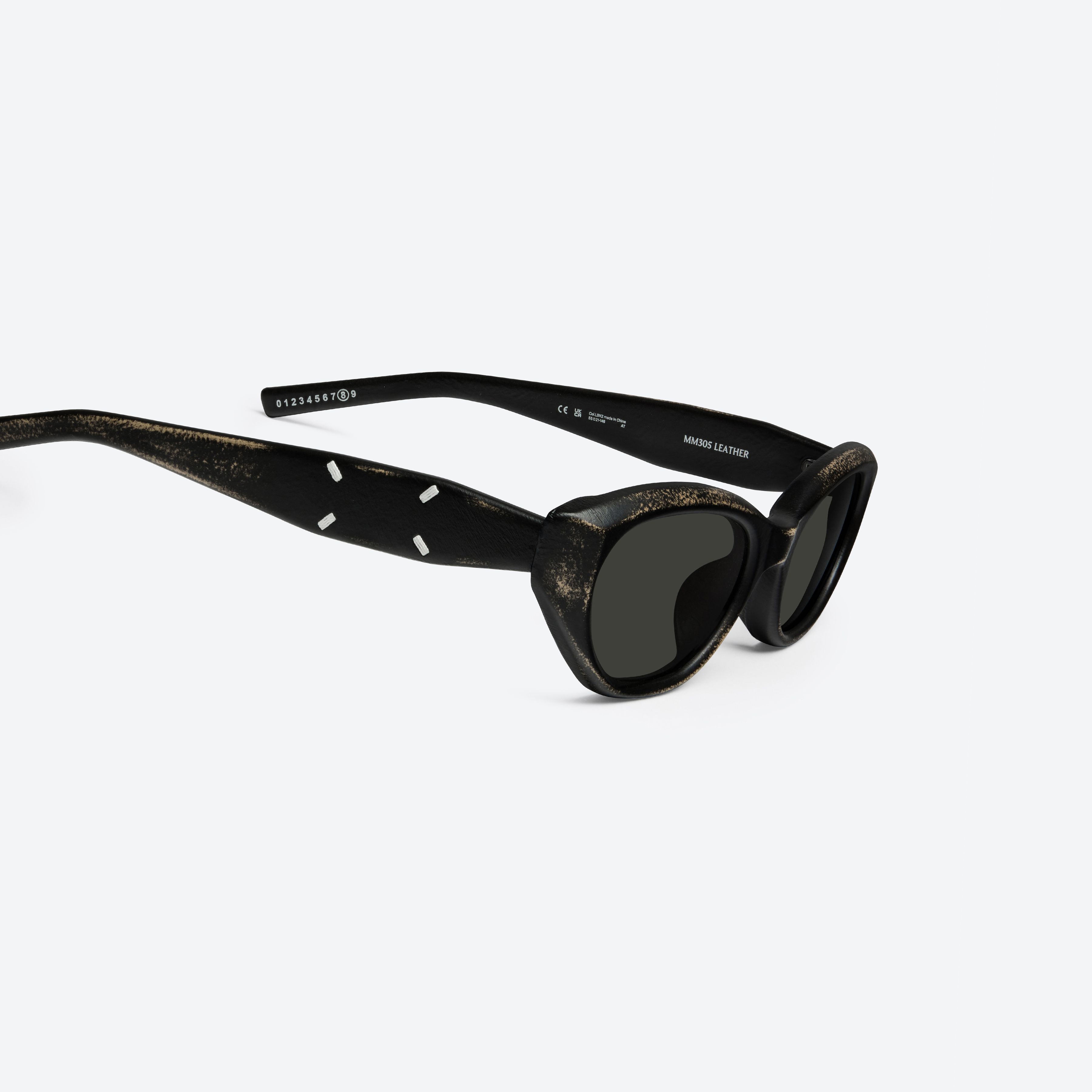 45-degree detailed view of Gentle Monster Maison Margiela - MM305 Leather LBK2 Similar Black Acetate framed Cat-eye sunglasses.