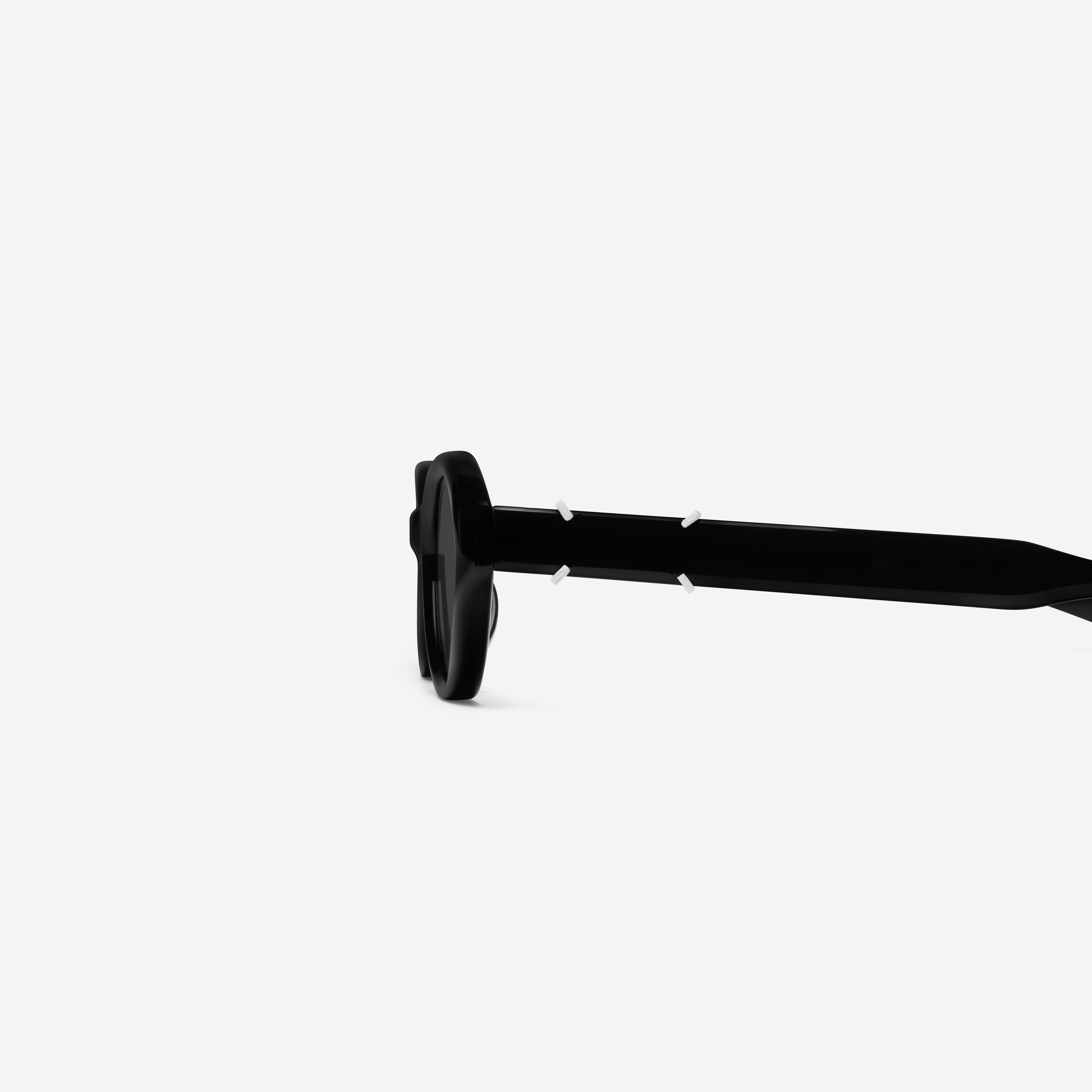 A detailed left view of Gentle Monster Maison Margiela - MM315 01 Black Acetate framed Oval sunglasses.
