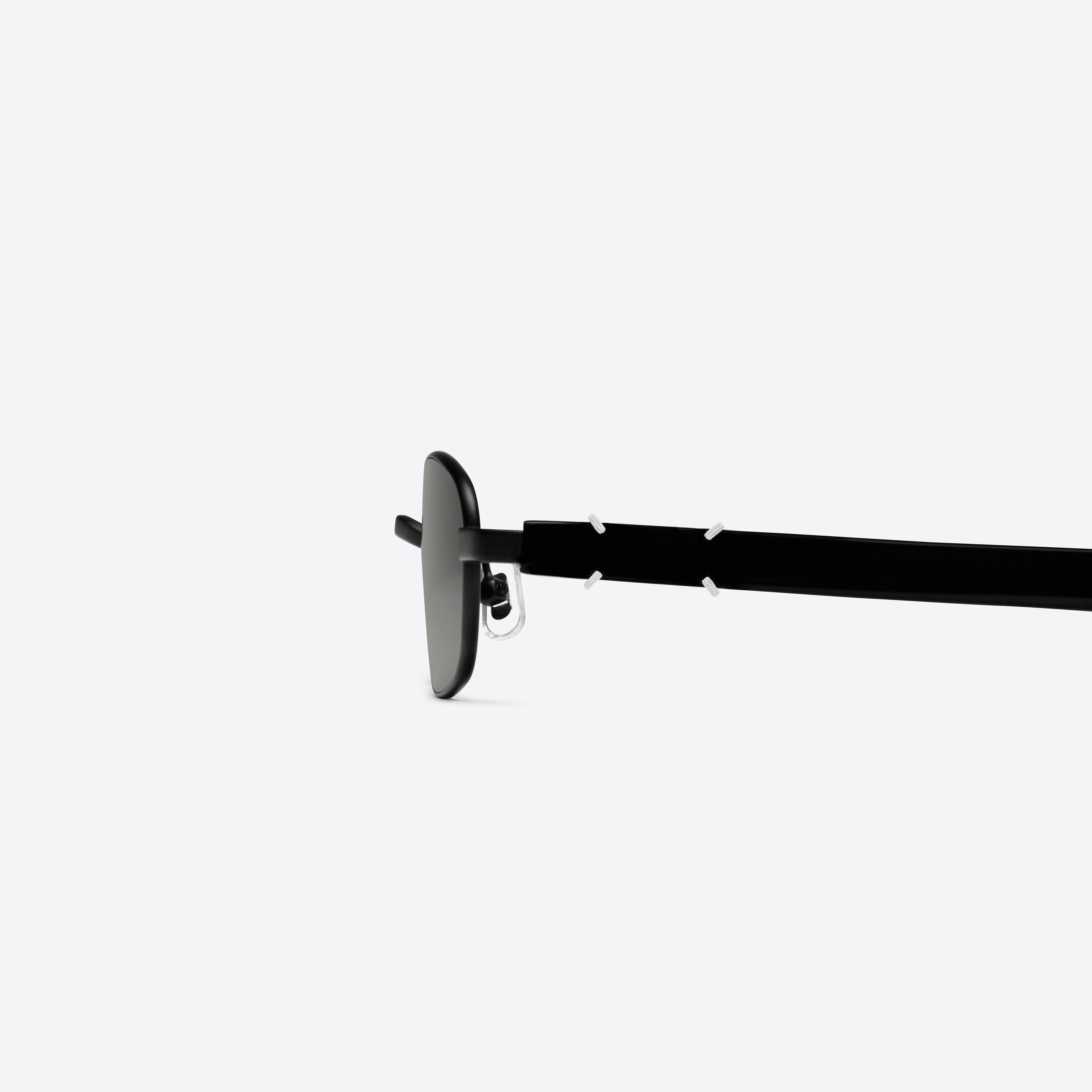 A detailed left view of Gentle Monster Maison Margiela - MM311 M01 Black Mixed framed Square sunglasses.
