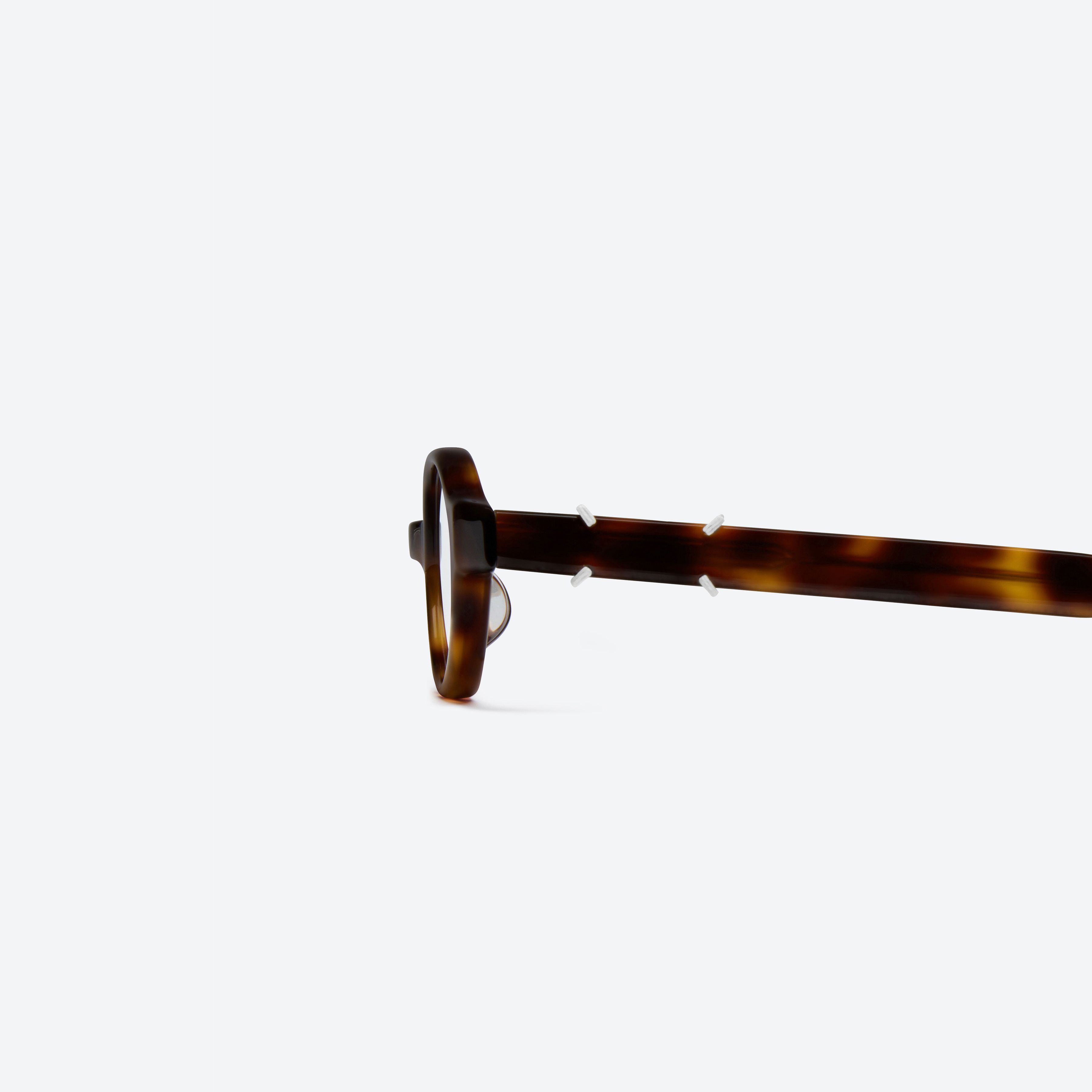 A detailed left view of Gentle Monster Maison Margiela - MM312 L2 Tortoise Acetate framed Oval glasses.