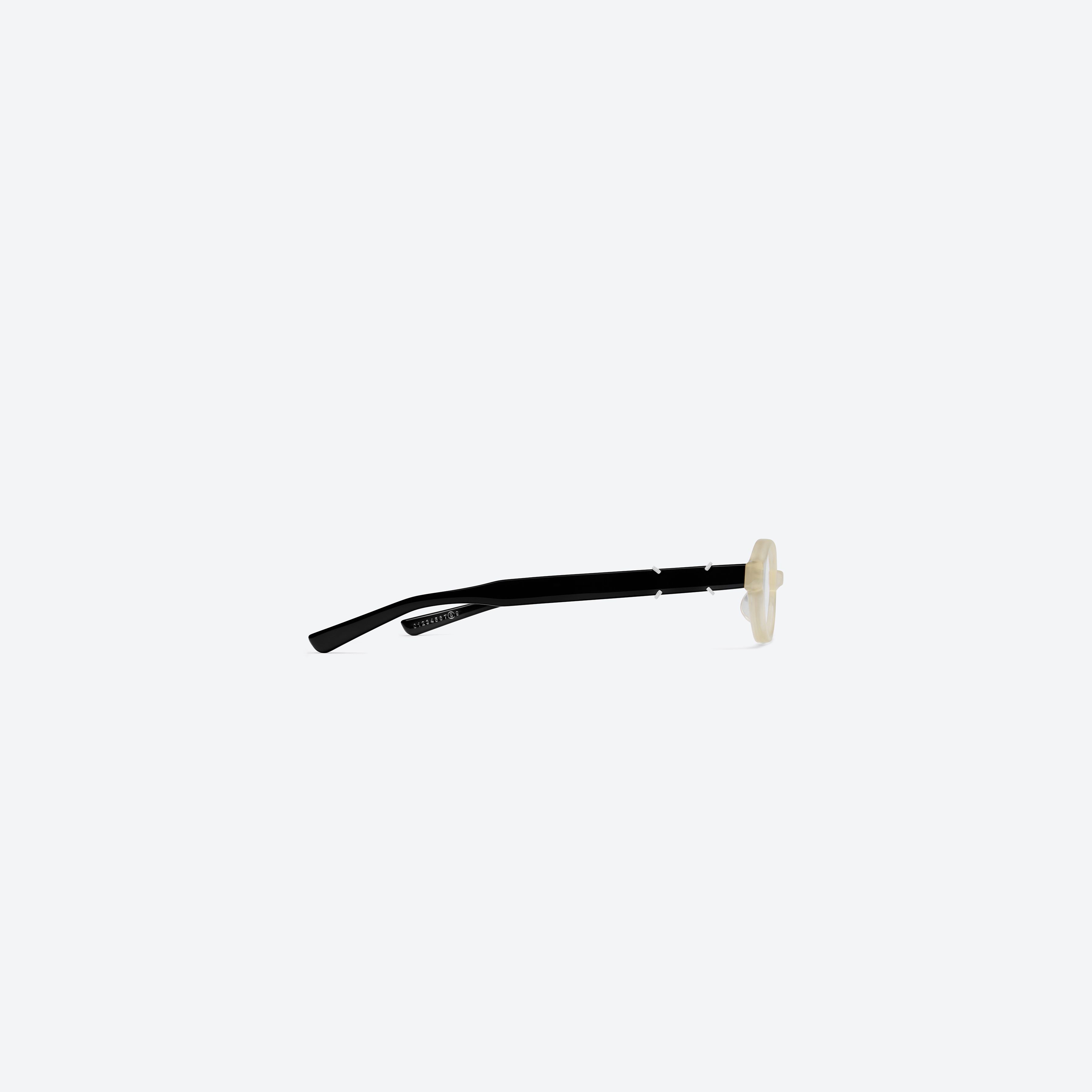 A detailed right view of Gentle Monster Maison Margiela - MM312 IC4 Ivory Acetate framed Oval glasses.