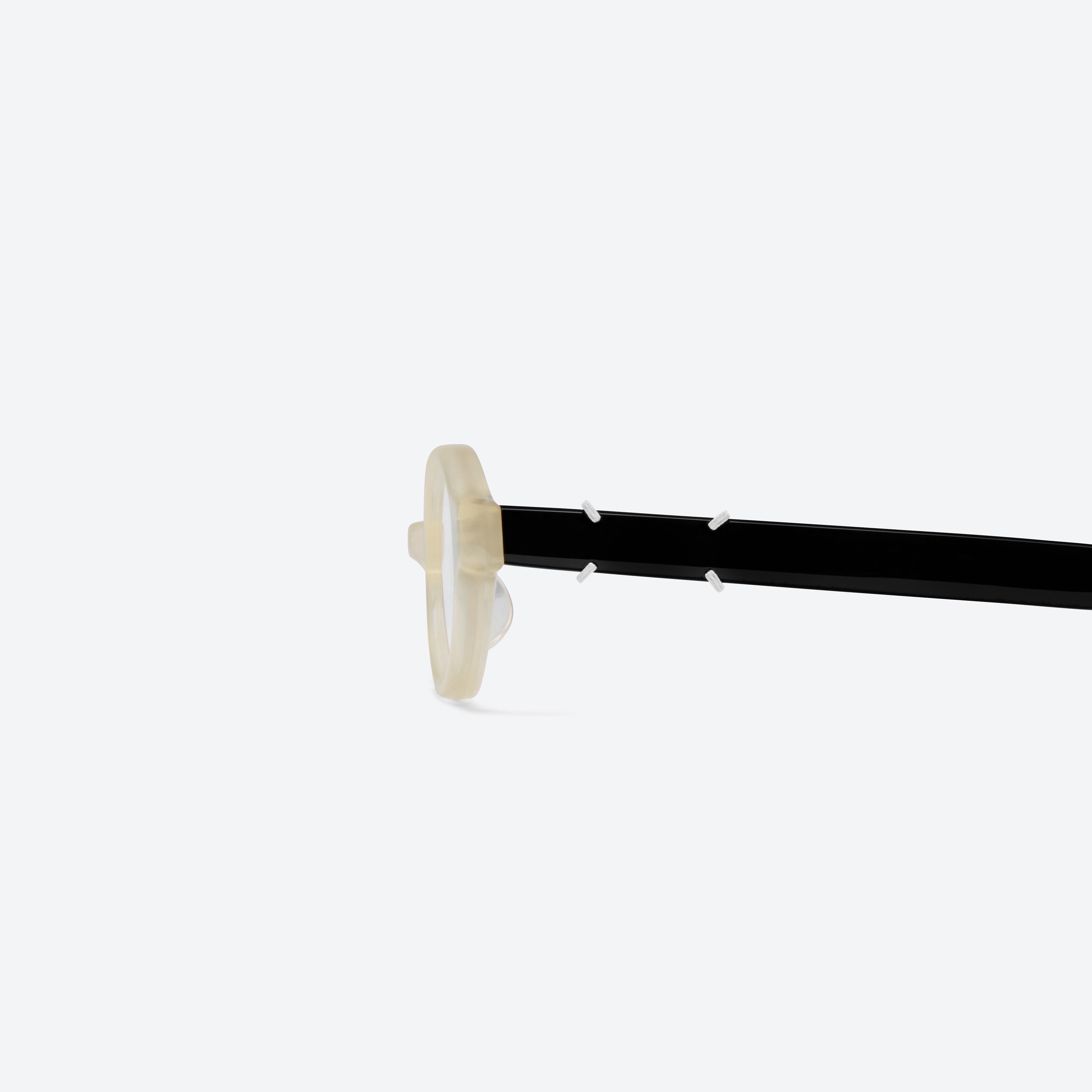 A detailed left view of Gentle Monster Maison Margiela - MM312 IC4 Ivory Acetate framed Oval glasses.
