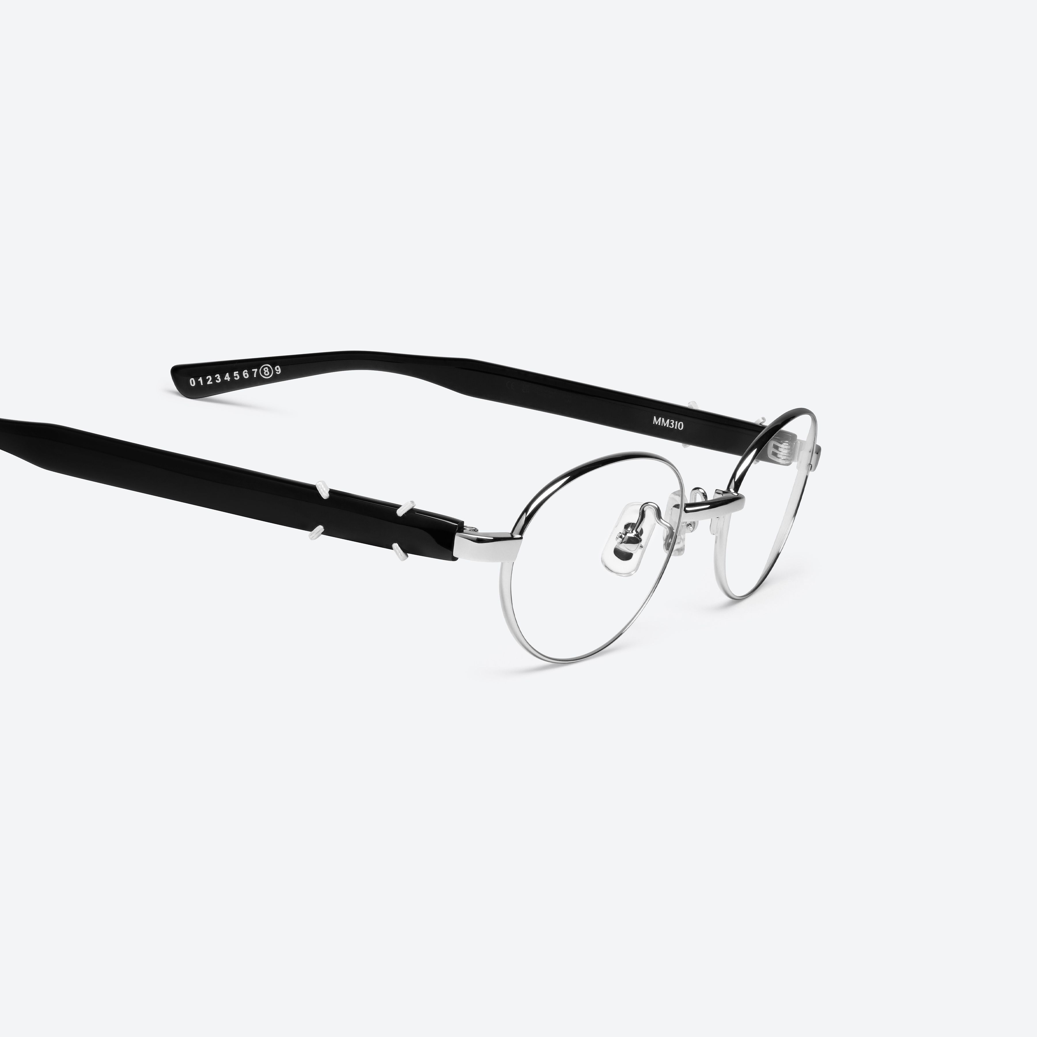 45-degree detailed view of Gentle Monster Maison Margiela - MM310 02 Silver Mixed framed Oval glasses.