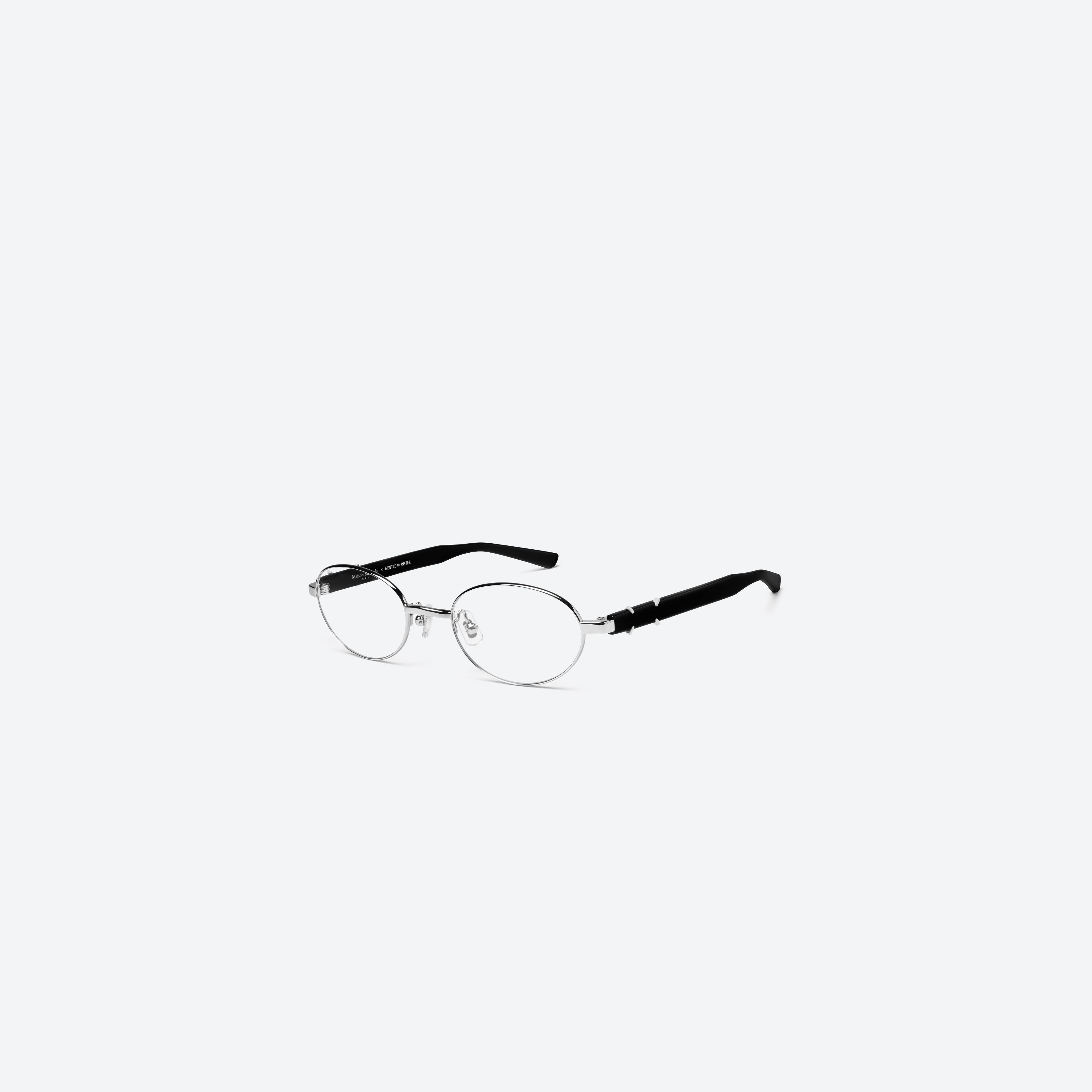 45-degree view of Gentle Monster Maison Margiela - MM310 02 Silver Mixed framed Oval glasses.