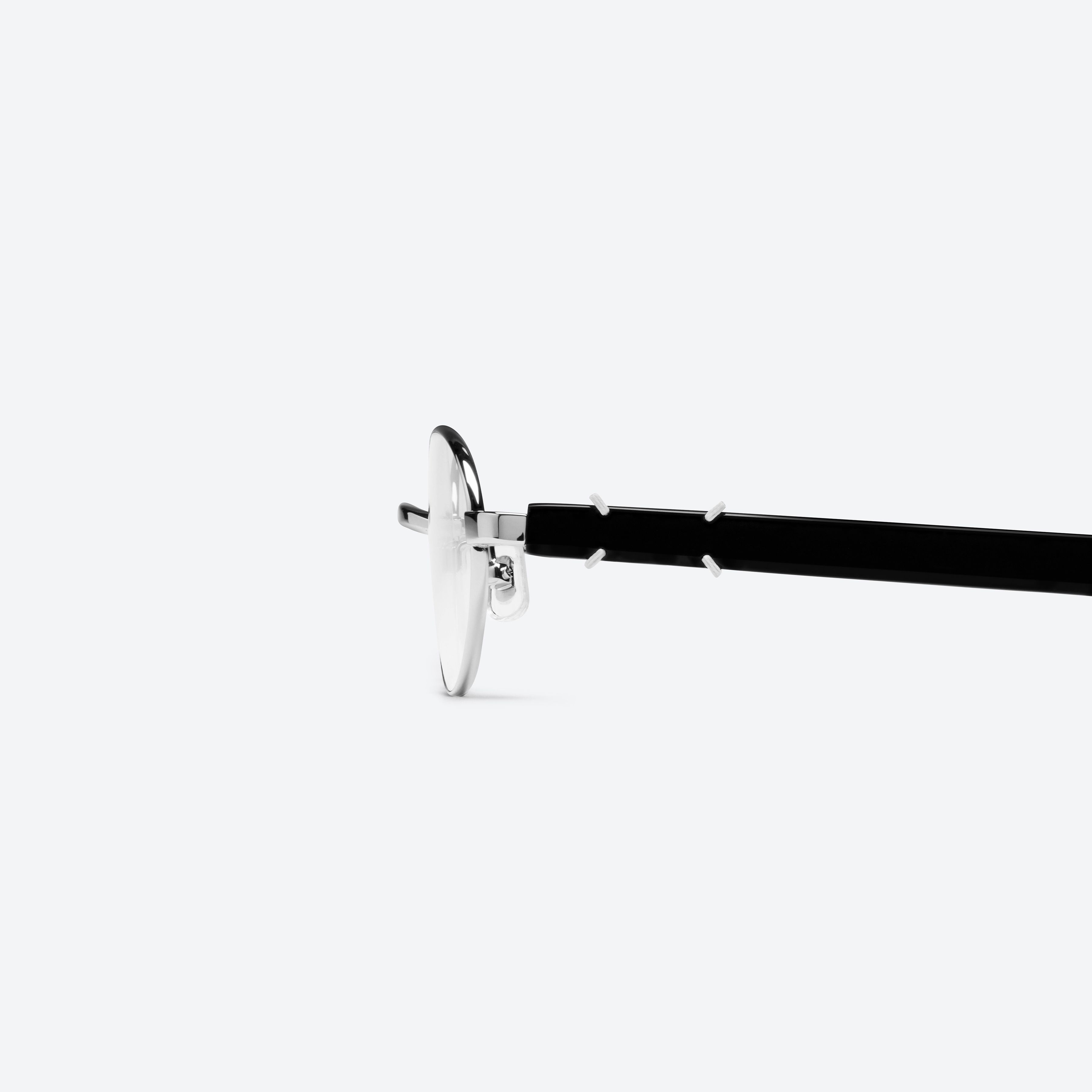A detailed left view of Gentle Monster Maison Margiela - MM310 02 Silver Mixed framed Oval glasses.