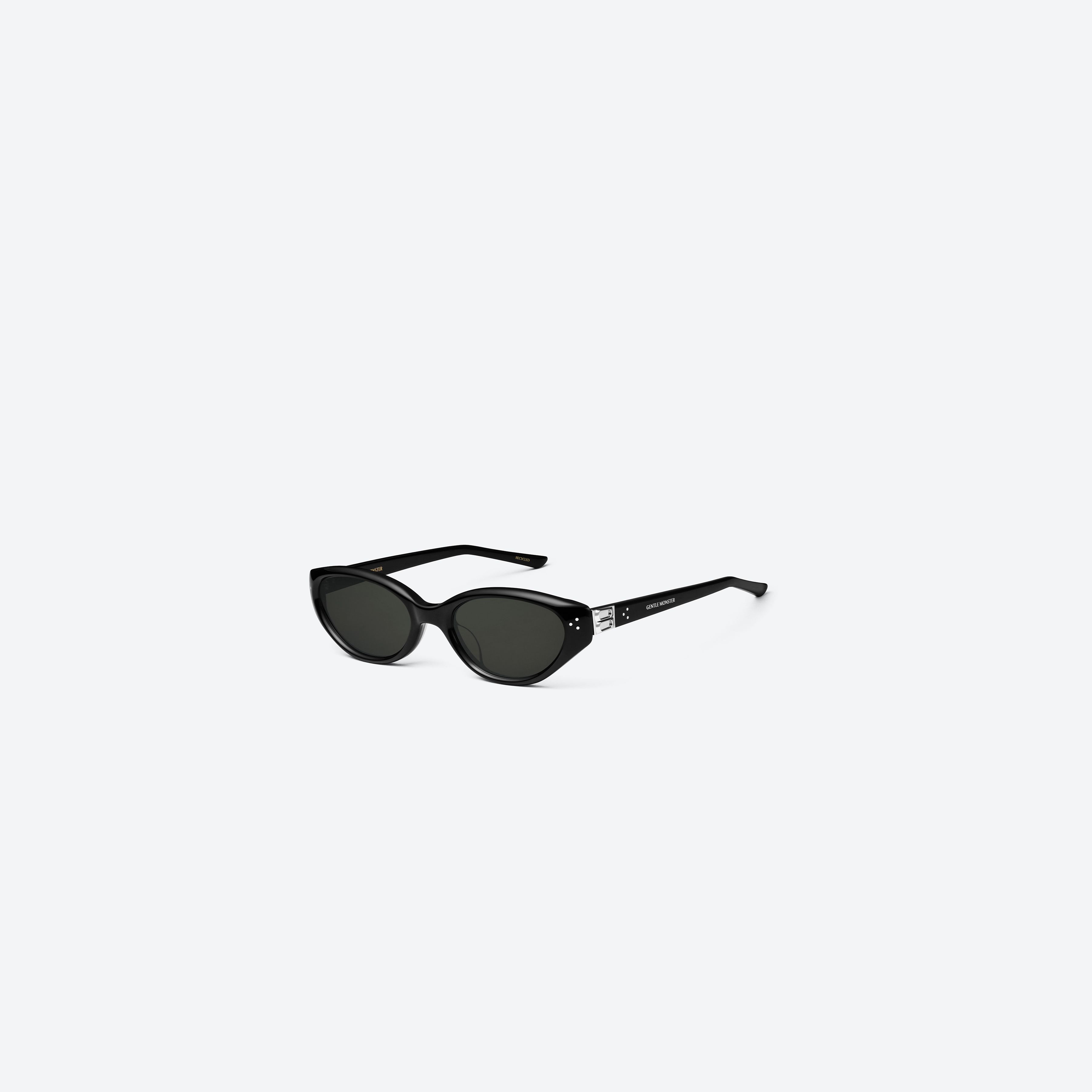 45-degree view of Gentle Monster Vanilla 01 Recycled Similar Black Acetate Renew framed Cat-eye sunglasses.
