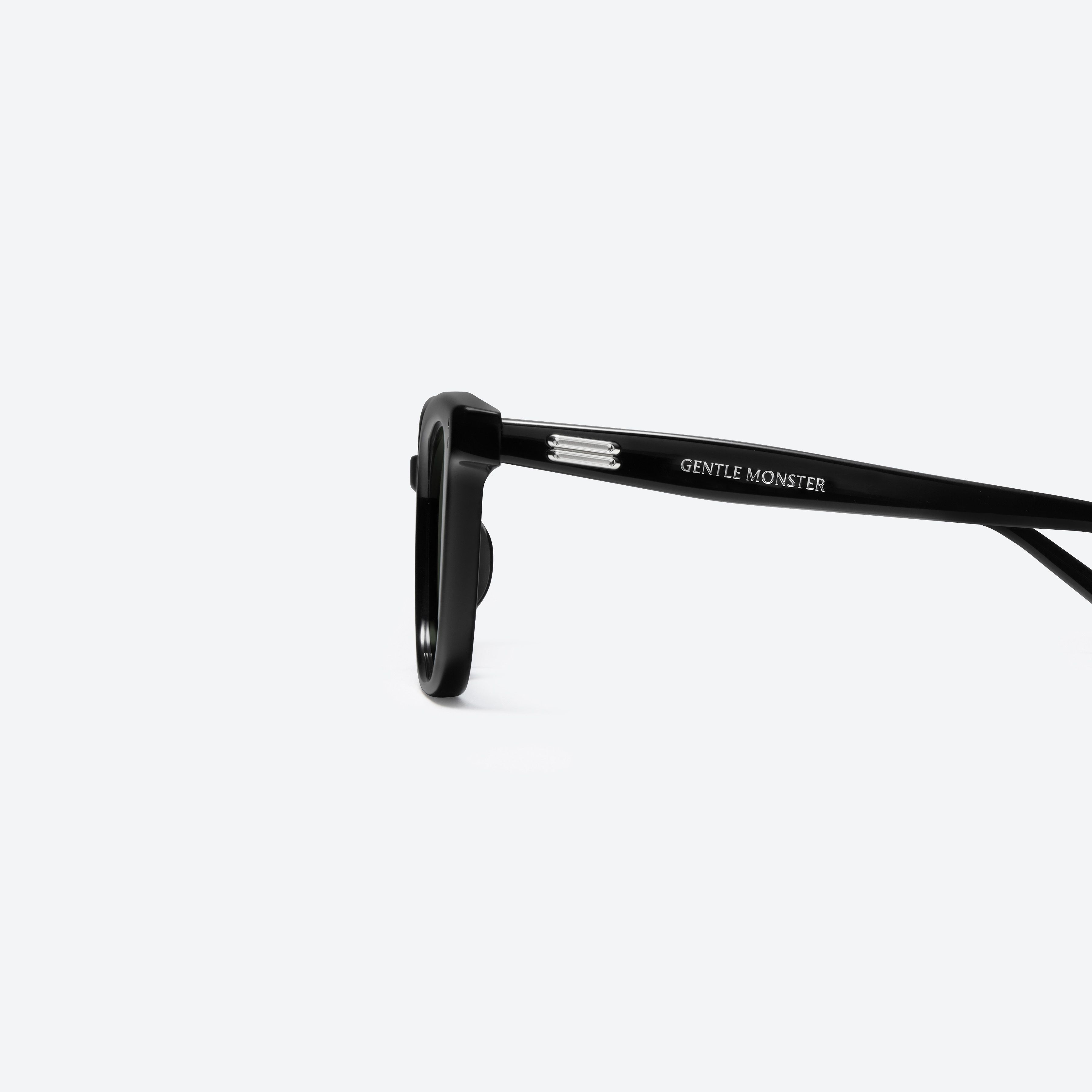 A detailed left view of Gentle Monster Daze 01 Recycled Similar Black Acetate Renew framed Square sunglasses.