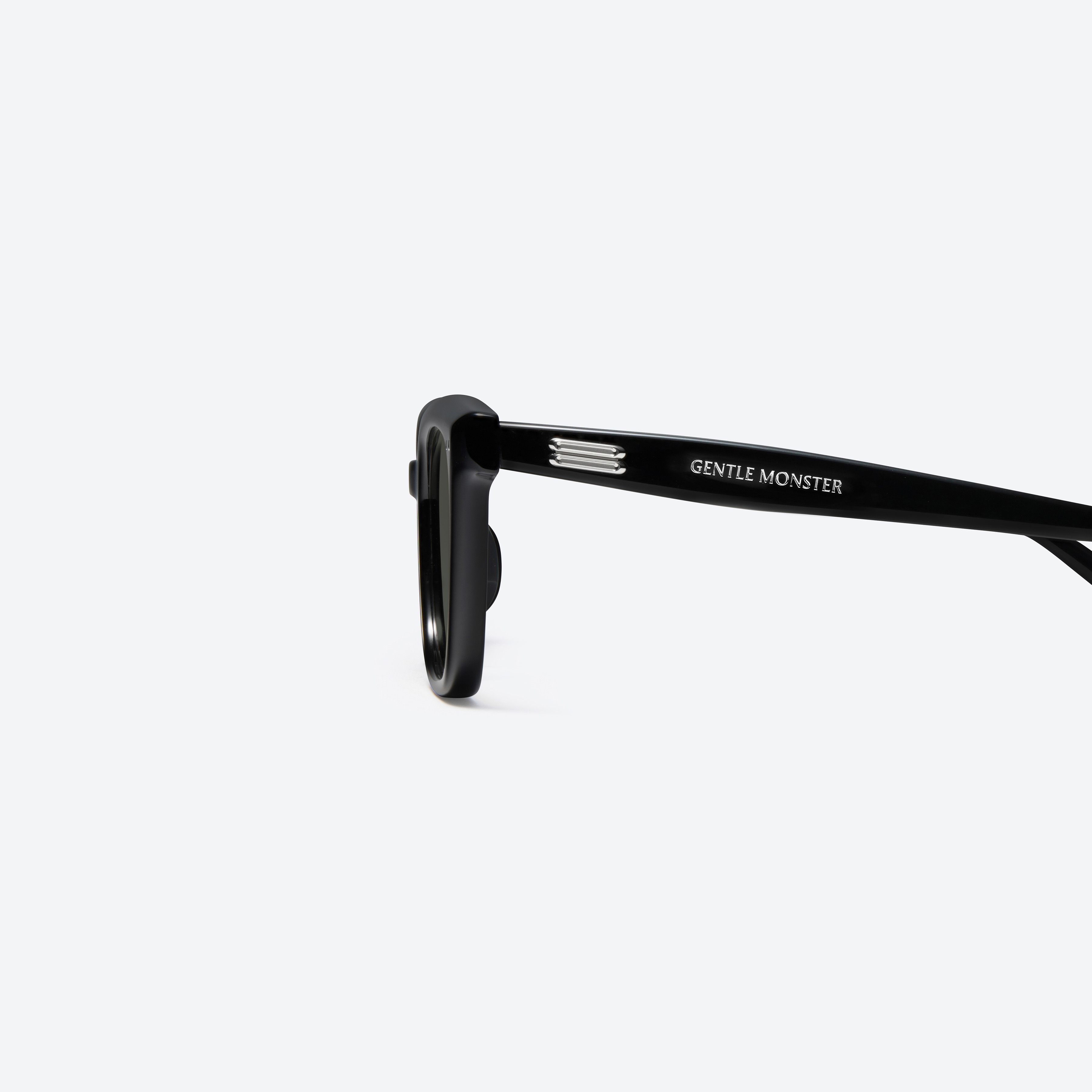 A detailed left view of Gentle Monster Soho 01 Recycled Similar Black Acetate Renew framed Square sunglasses.