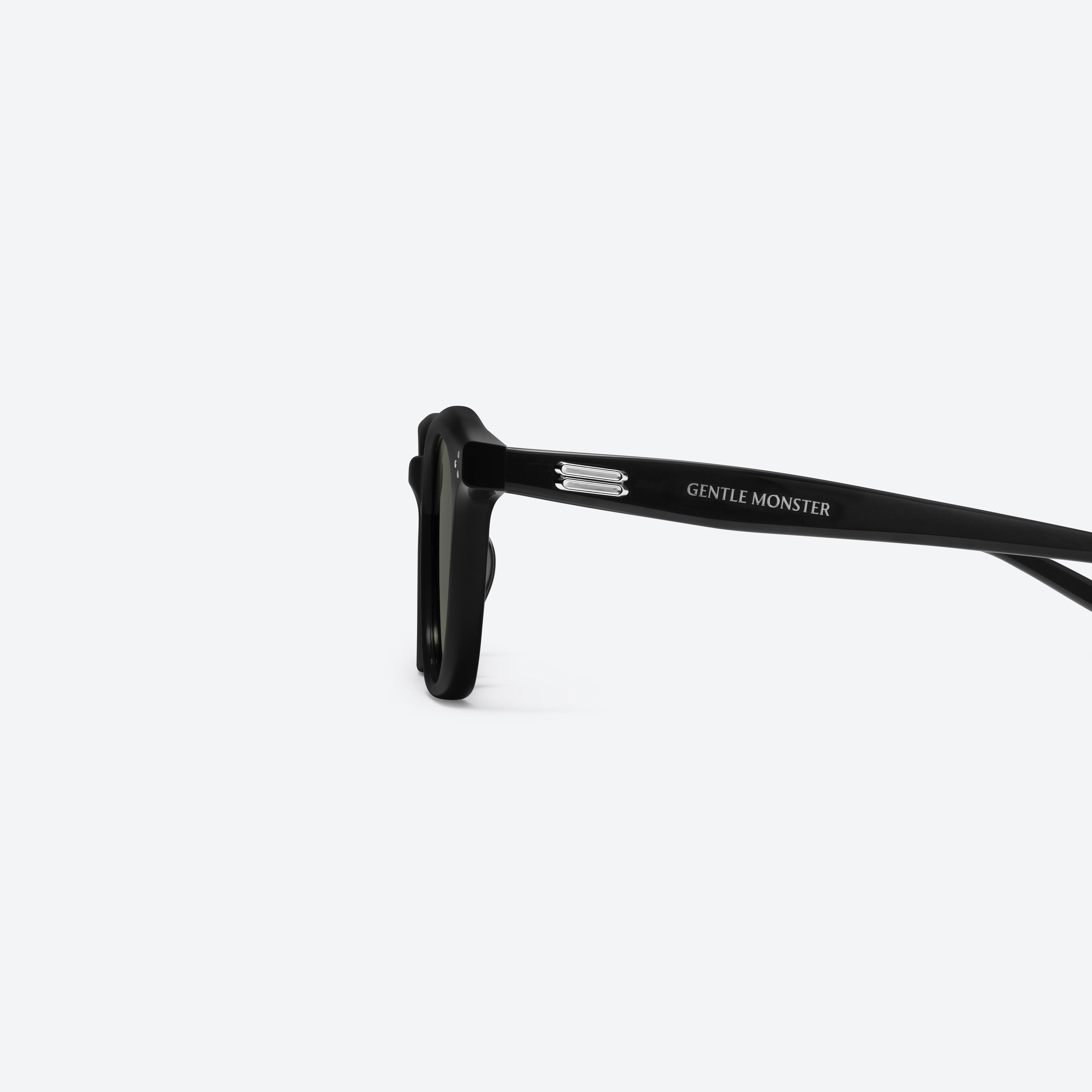 A detailed left view of Gentle Monster Noho 01 Recycled Similar Black Acetate Renew framed Round sunglasses.