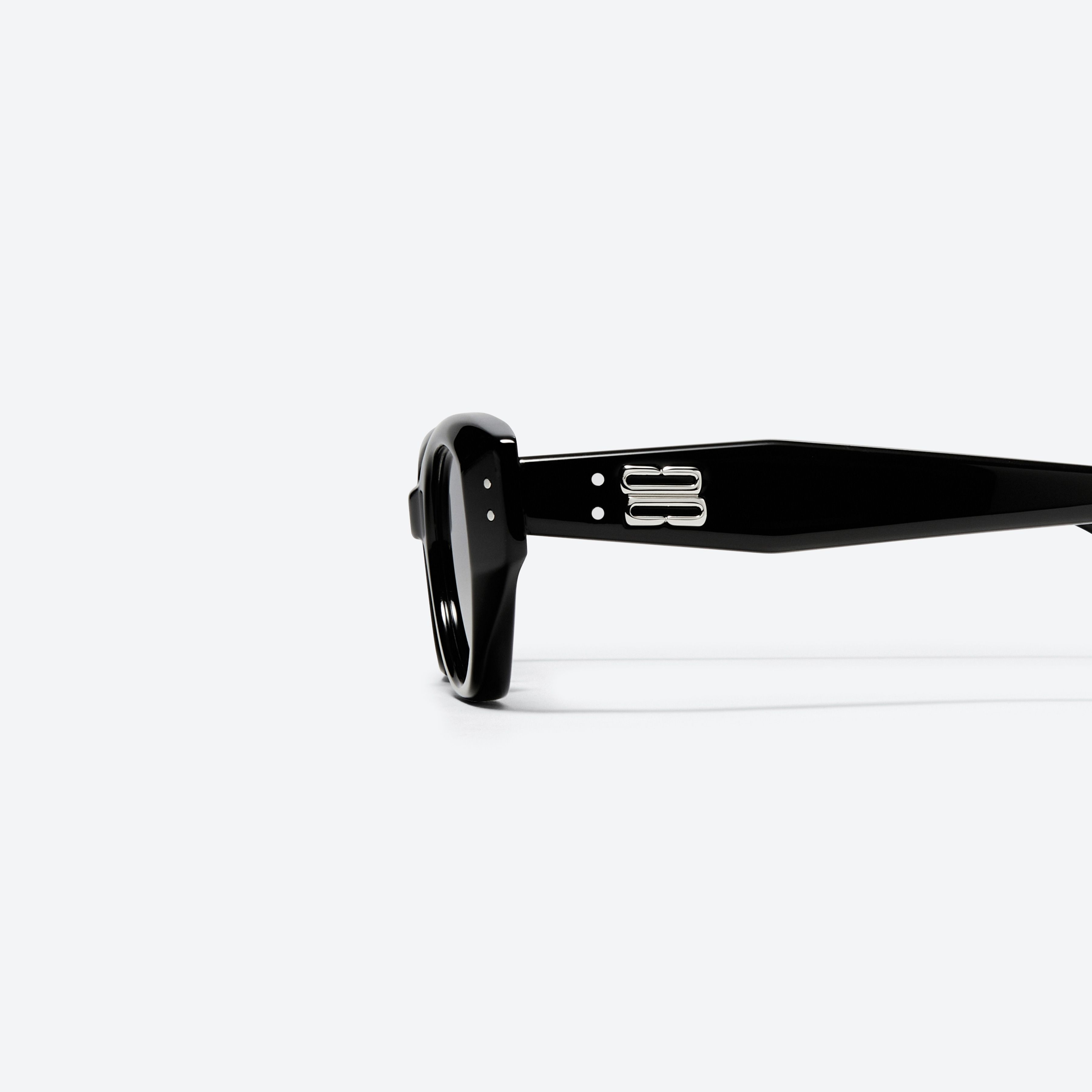 A detailed left view of Gentle Monster Rococo 01 Recycled Similar Black Acetate Renew framed Cat-eye sunglasses.