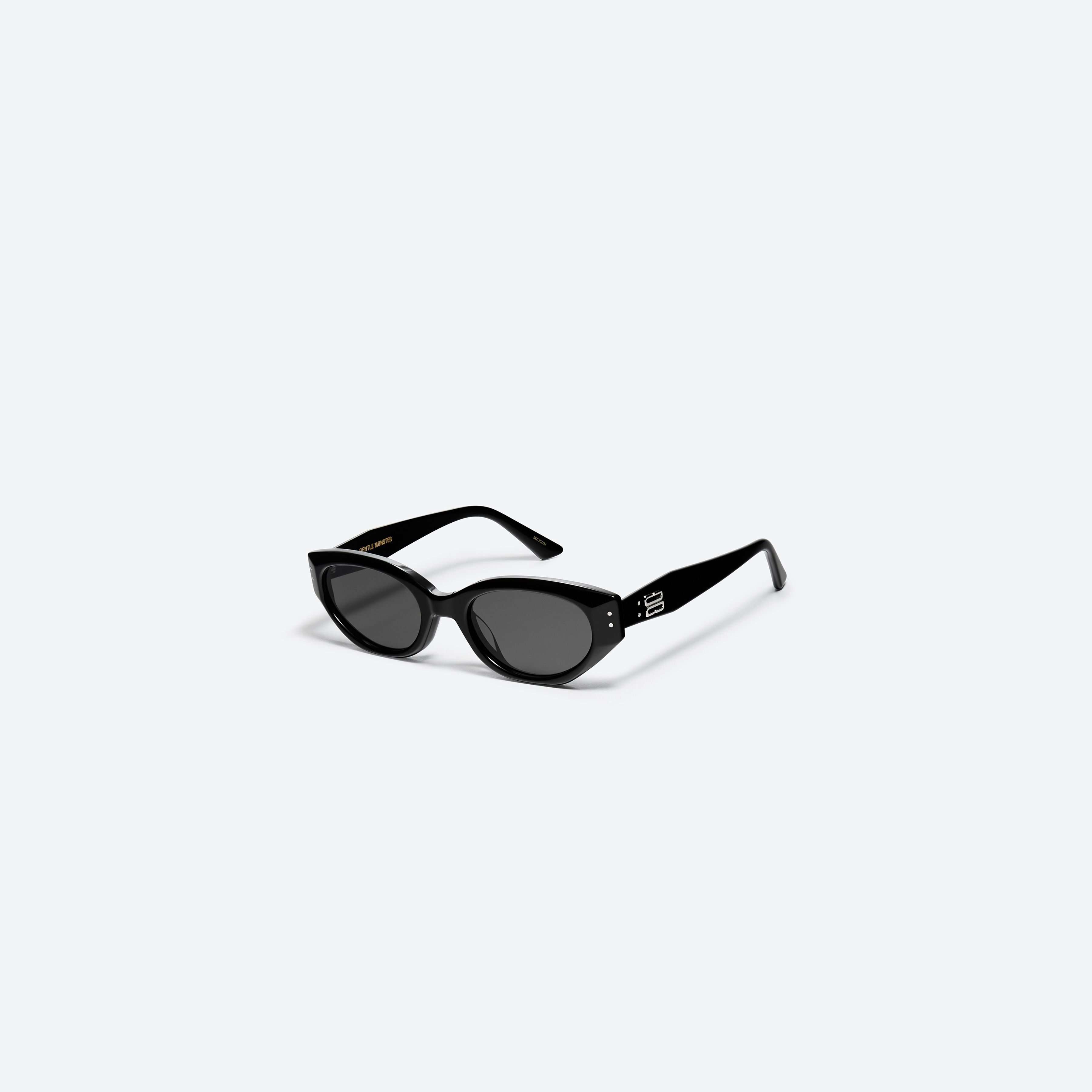 45-degree view of Gentle Monster Rococo 01 Recycled Similar Black Acetate Renew framed Cat-eye sunglasses.
