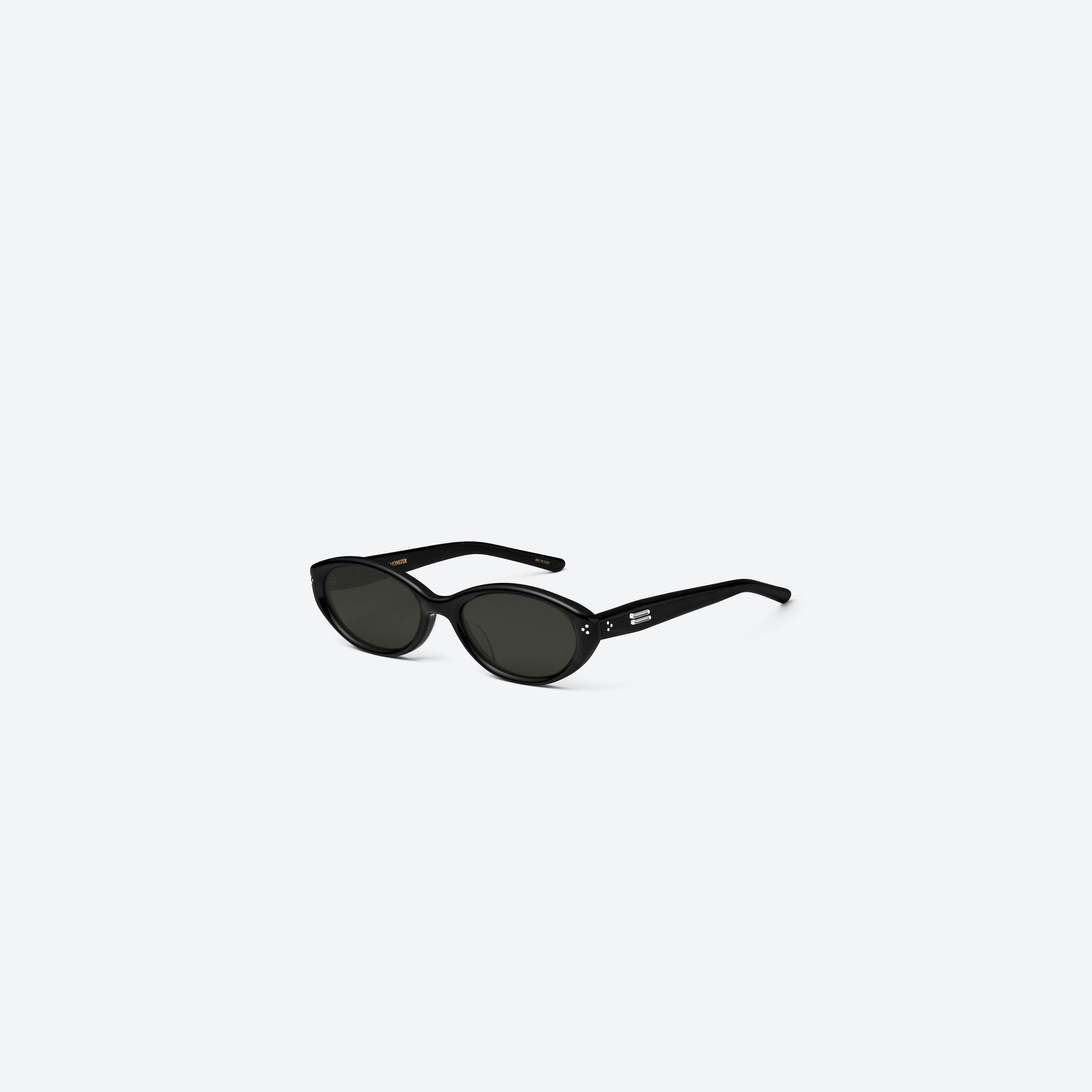 45-degree view of Gentle Monster Cuscus 01 Recycled Similar Black Acetate Renew framed Oval sunglasses.