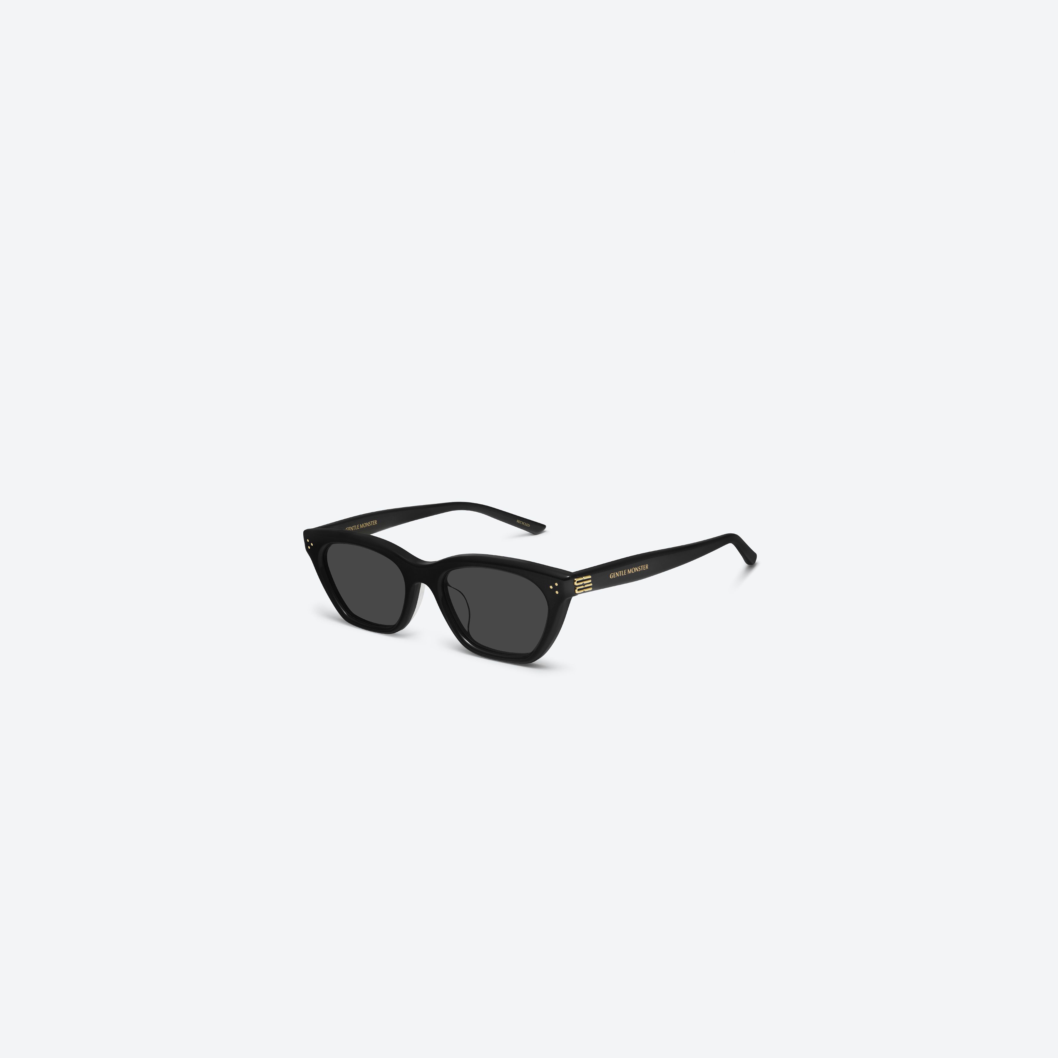 45-degree view of Gentle Monster Gisele 01 Recycled Similar Black Acetate Renew framed Cat-eye sunglasses.