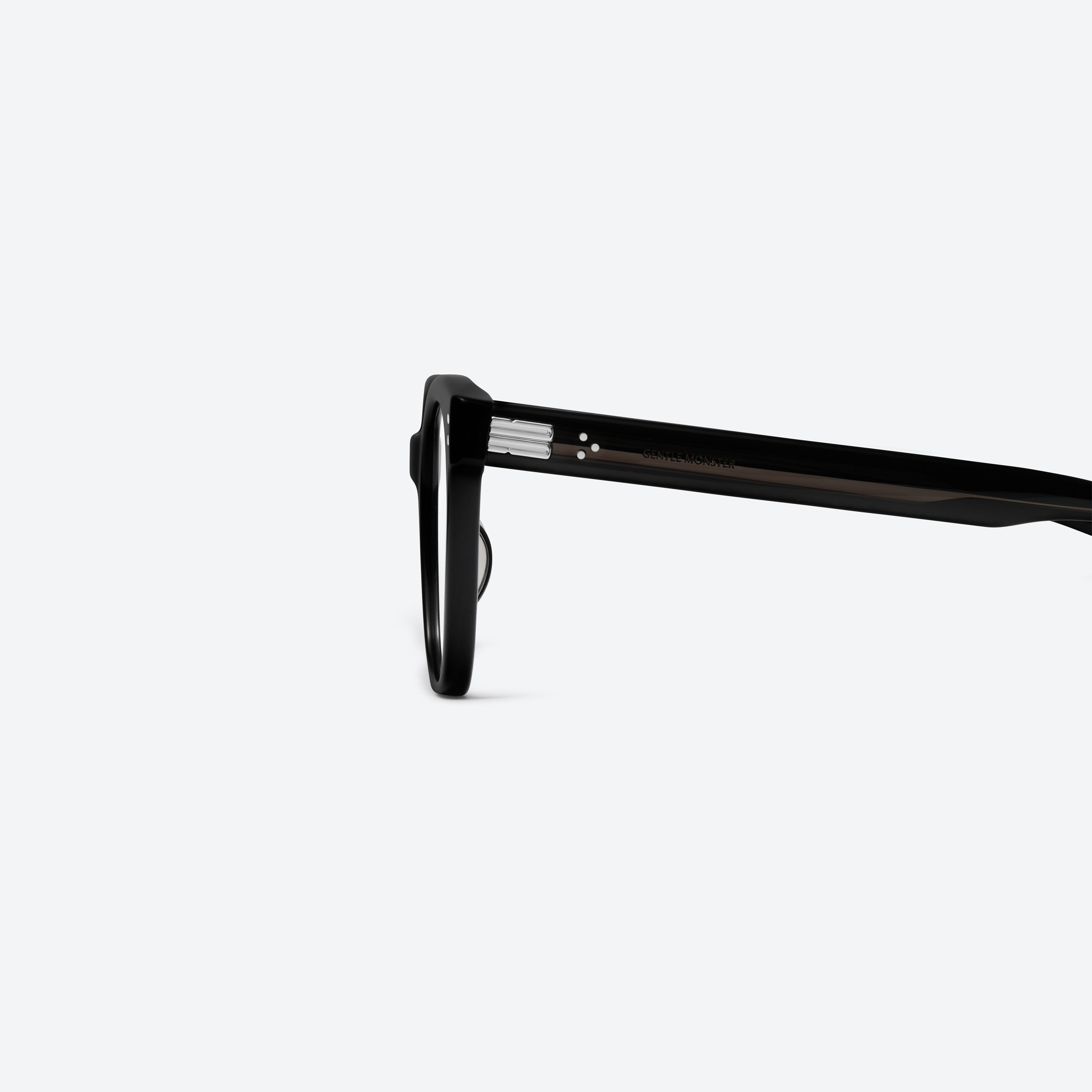 A detailed left view of Gentle Monster Una.c W 01 Black Acetate framed Square glasses.
