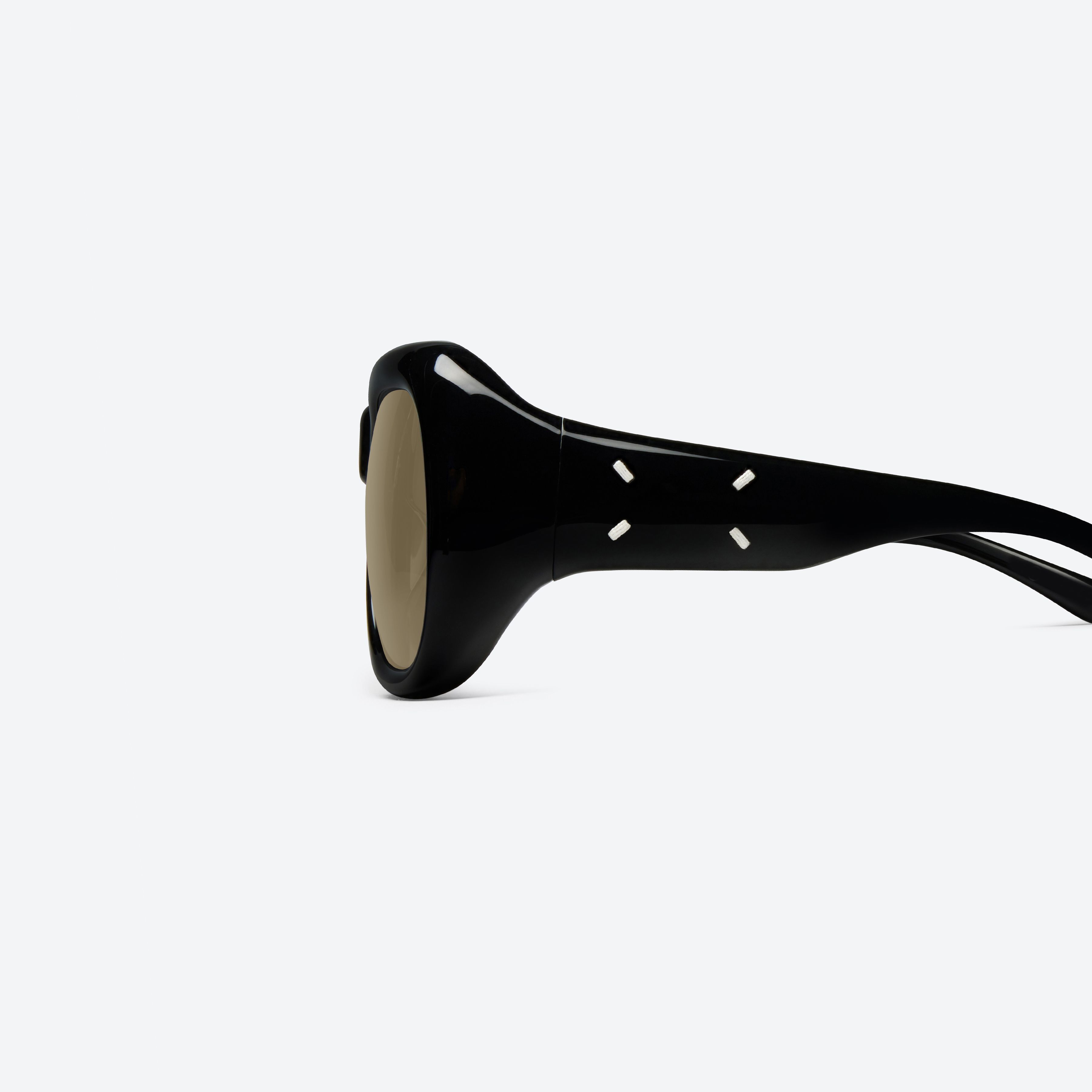 A detailed left view of Gentle Monster Maison Margiela - MM323 01 Black Acetate framed Aviator sunglasses.