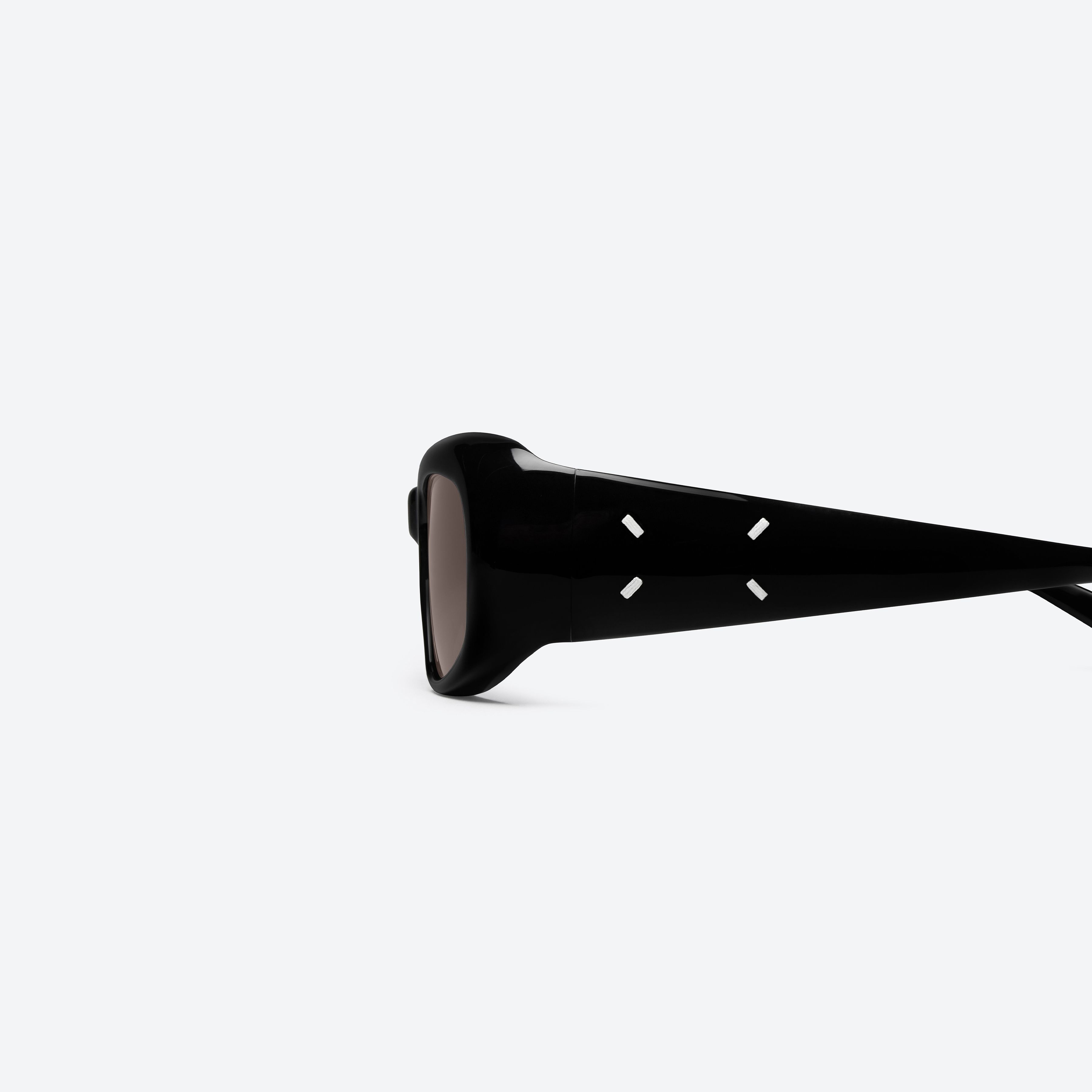 A detailed left view of Gentle Monster Maison Margiela - MM324 01 Black Acetate framed Square sunglasses.