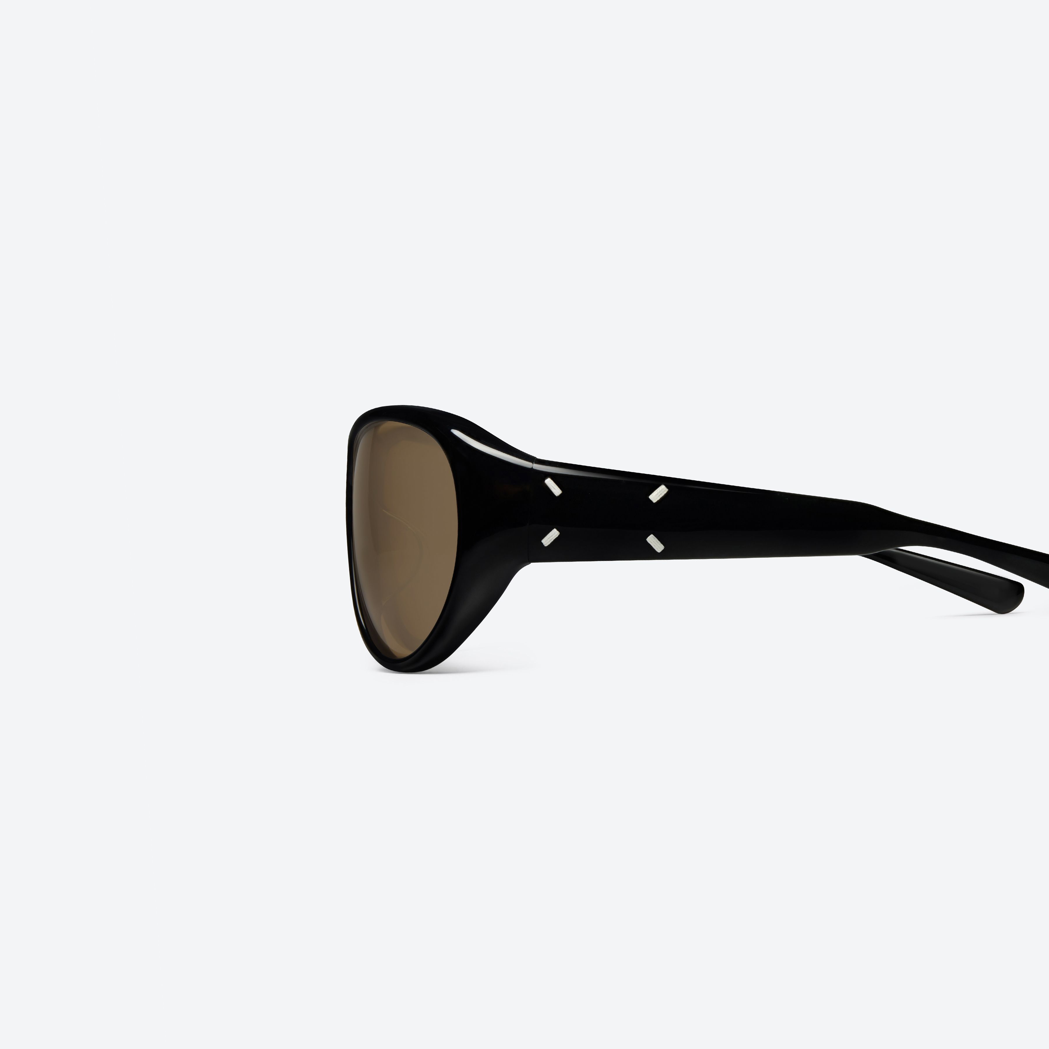 A detailed left view of Gentle Monster Maison Margiela - MM325 01 Black Acetate framed Aviator sunglasses.