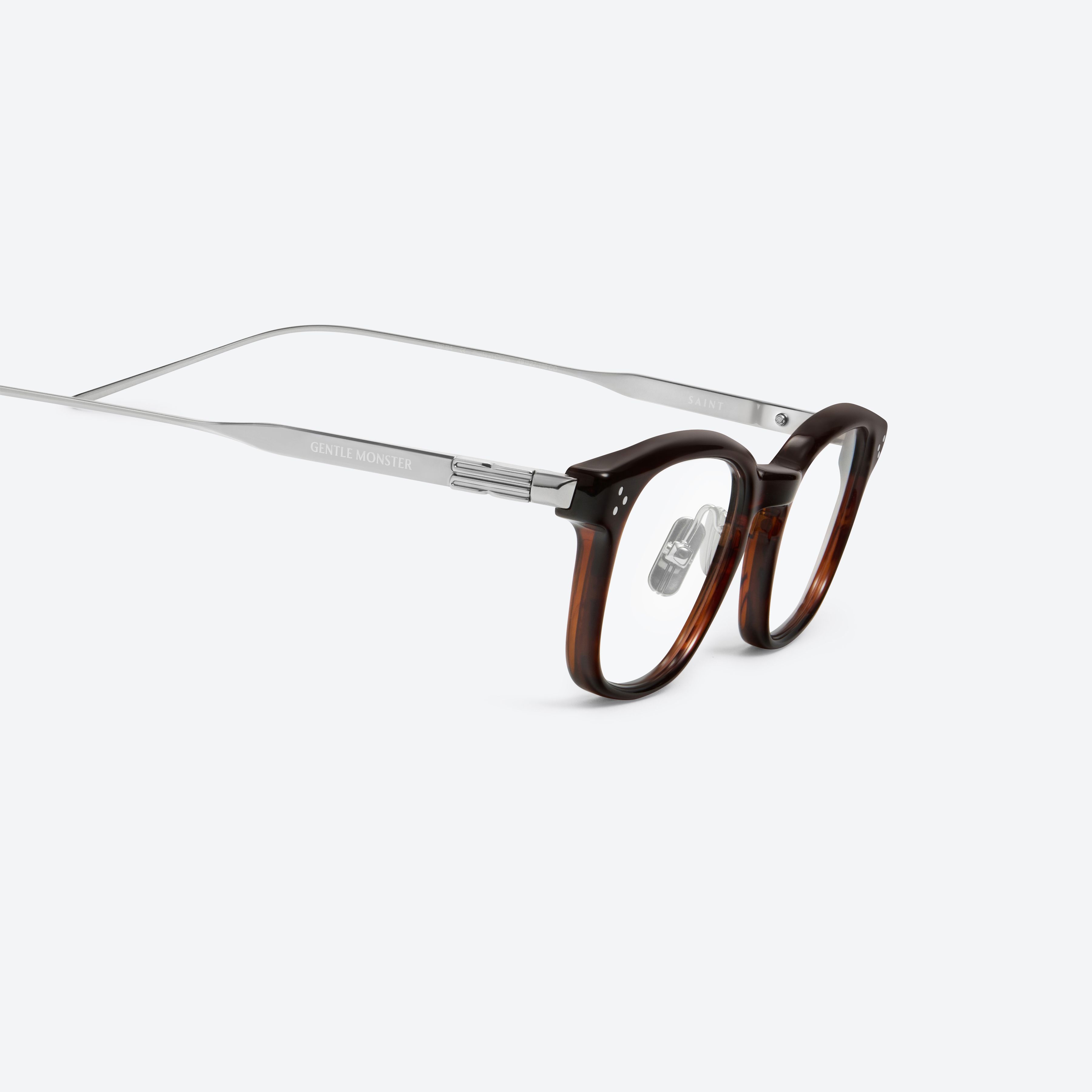 45-degree detailed view of Gentle Monster Saint B4 Similar Brown Mixed framed Square glasses.