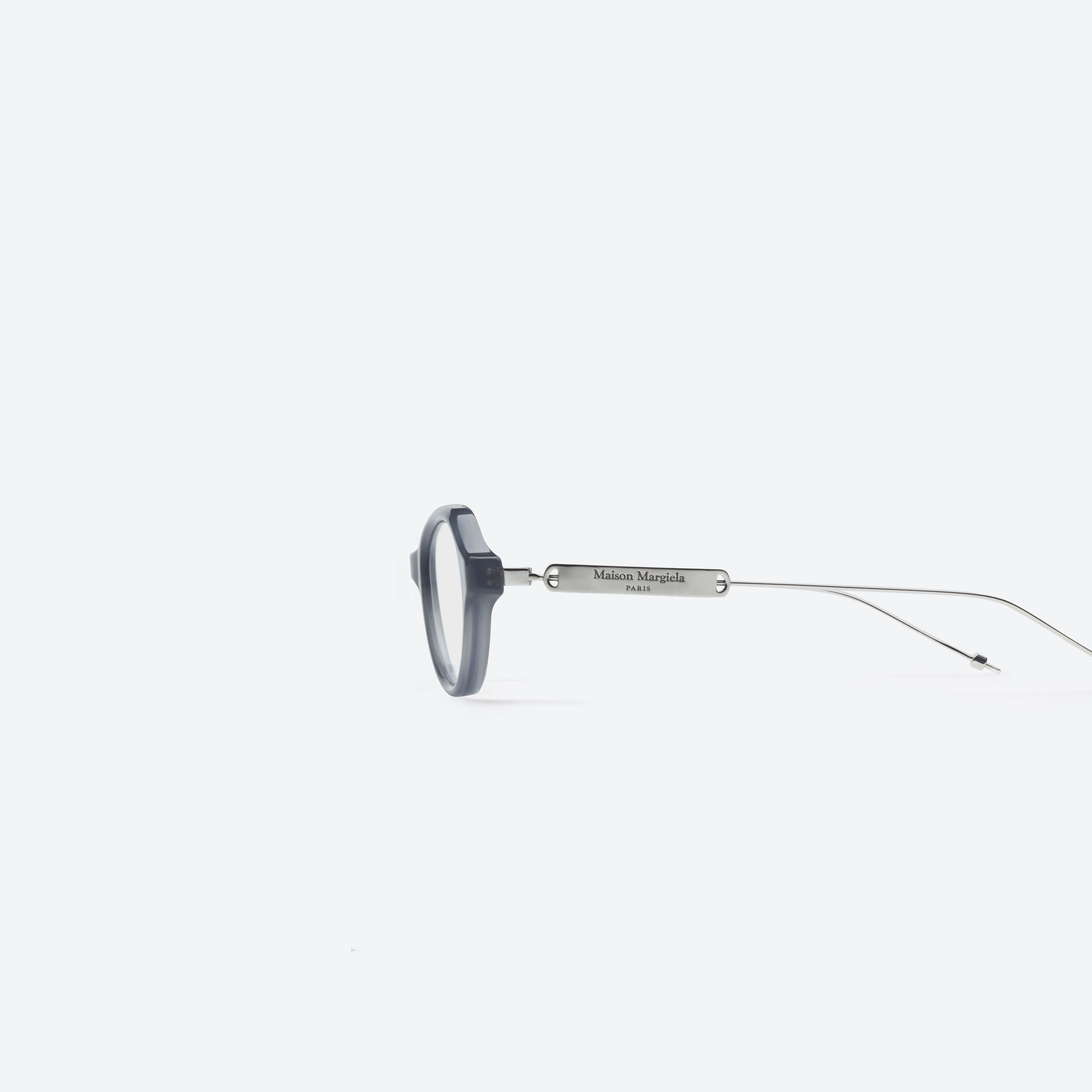 A detailed left view of Gentle Monster Maison Margiela - MM214 GC11 Gray Mixed framed Round glasses.