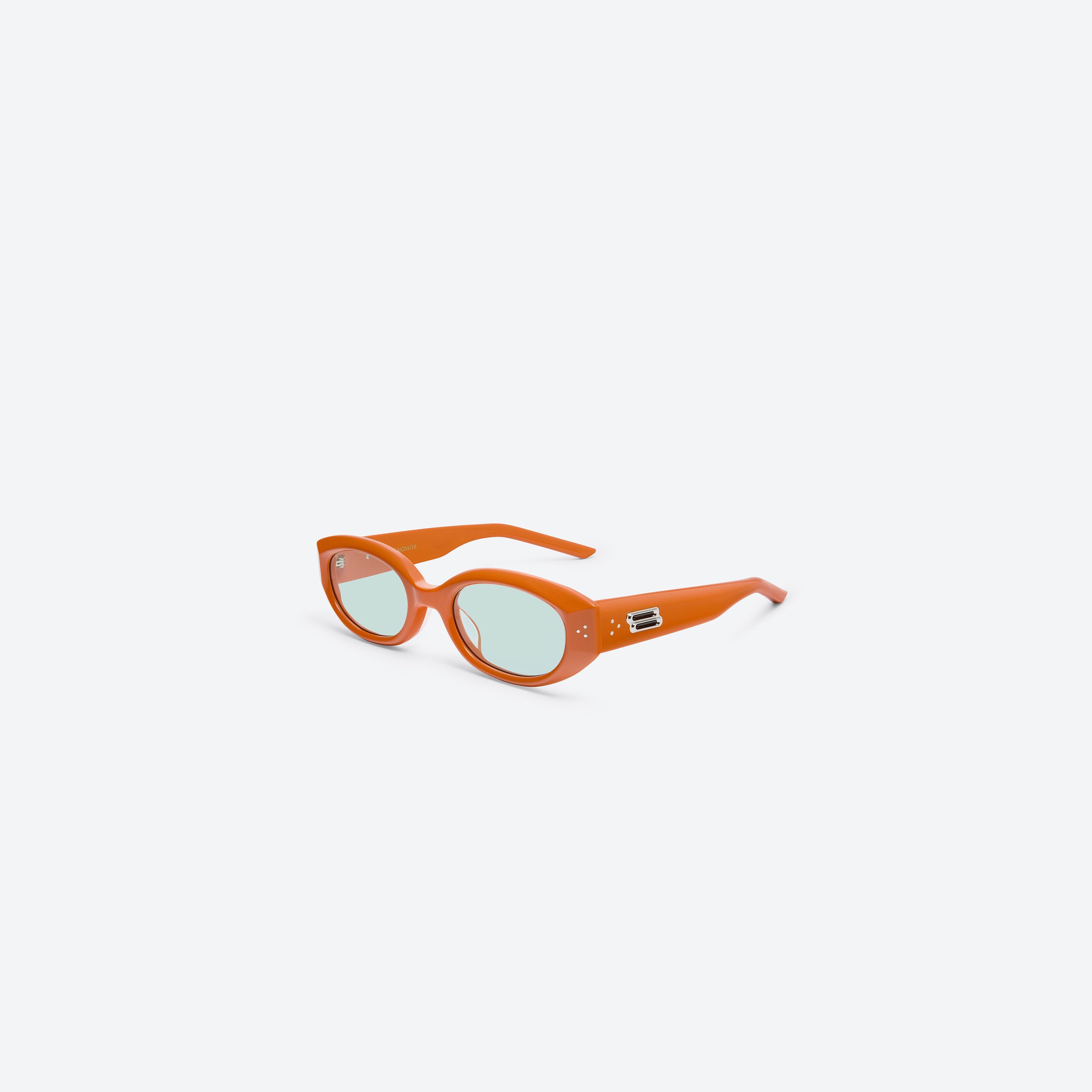 45-degree view of Gentle Monster Void OR3 Orange Acetate framed Oval sunglasses.