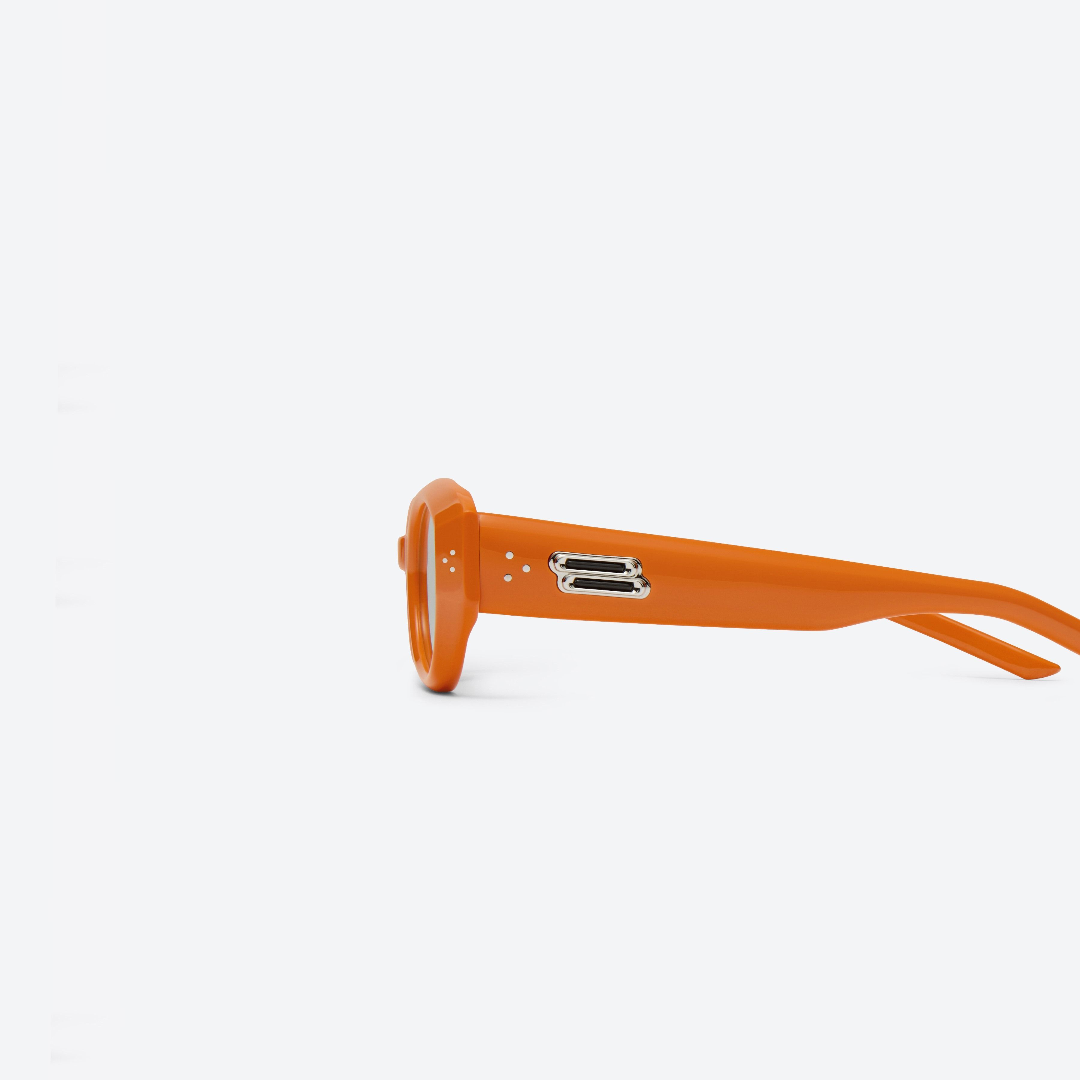 A detailed left view of Gentle Monster Void OR3 Orange Acetate framed Oval sunglasses.