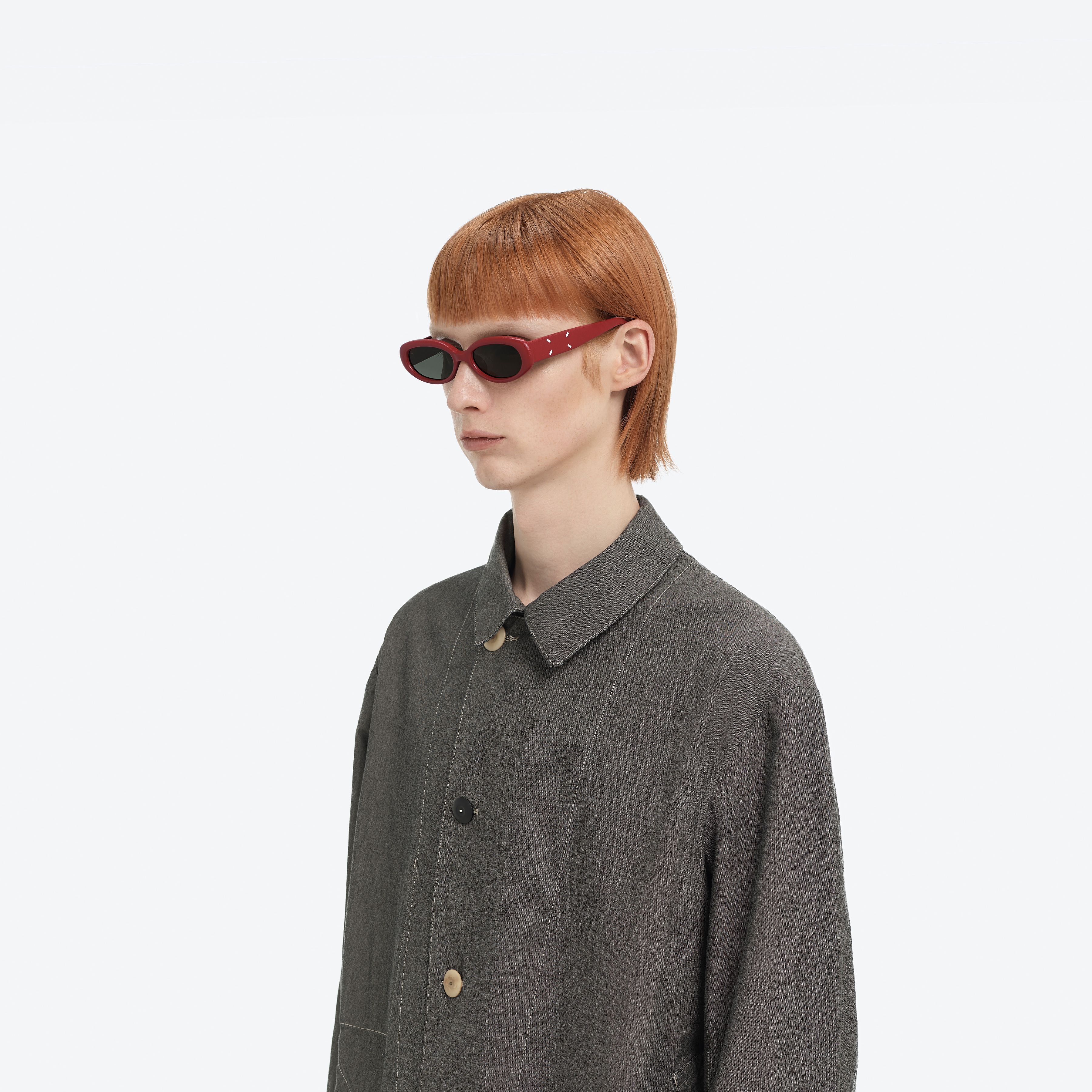 Model wearing the MM206 LEATHER LR1 Red Acetate framed Oval sunglasses.