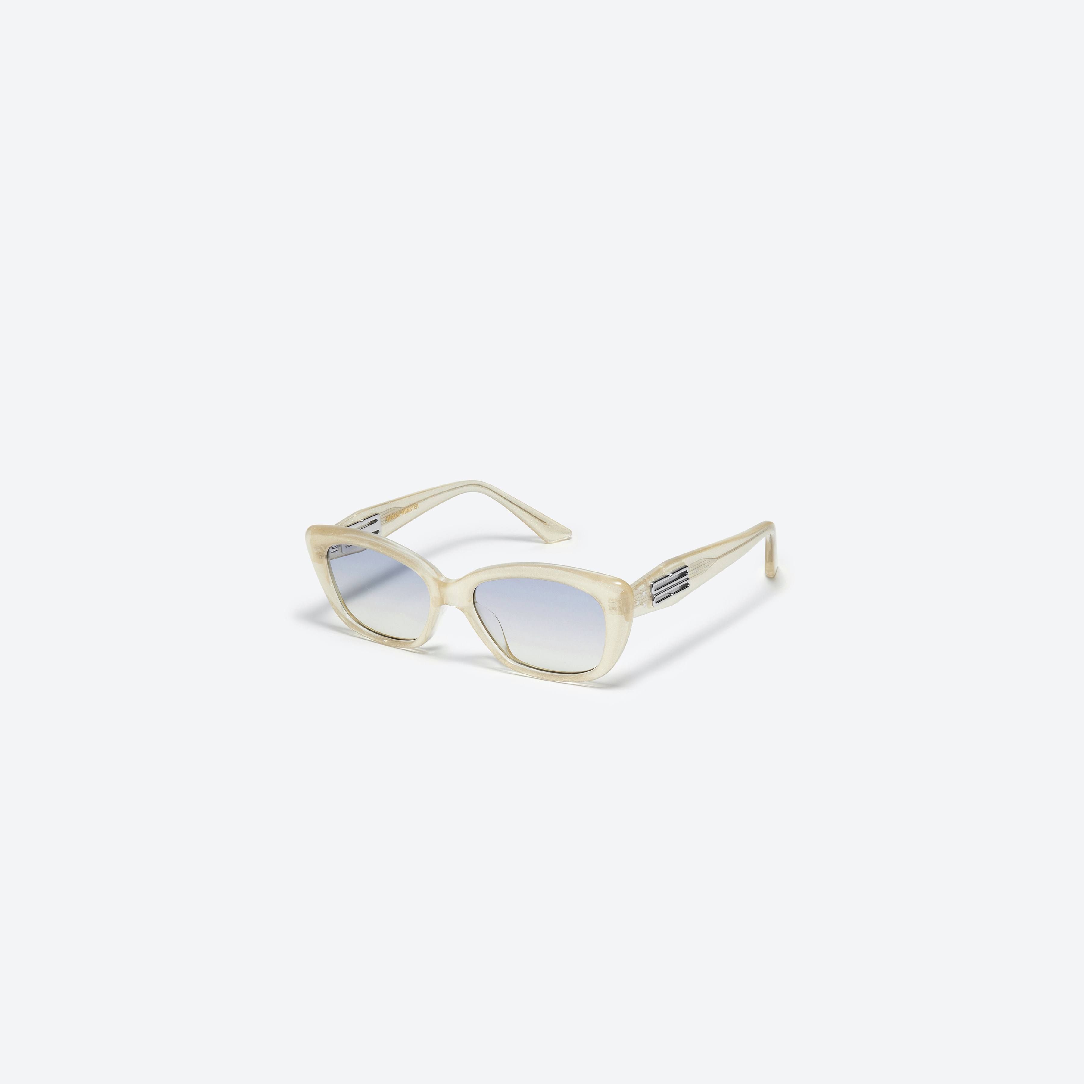 45-degree view of Gentle Monster Amber GDC1 Gold Acetate framed Cat-eye sunglasses.