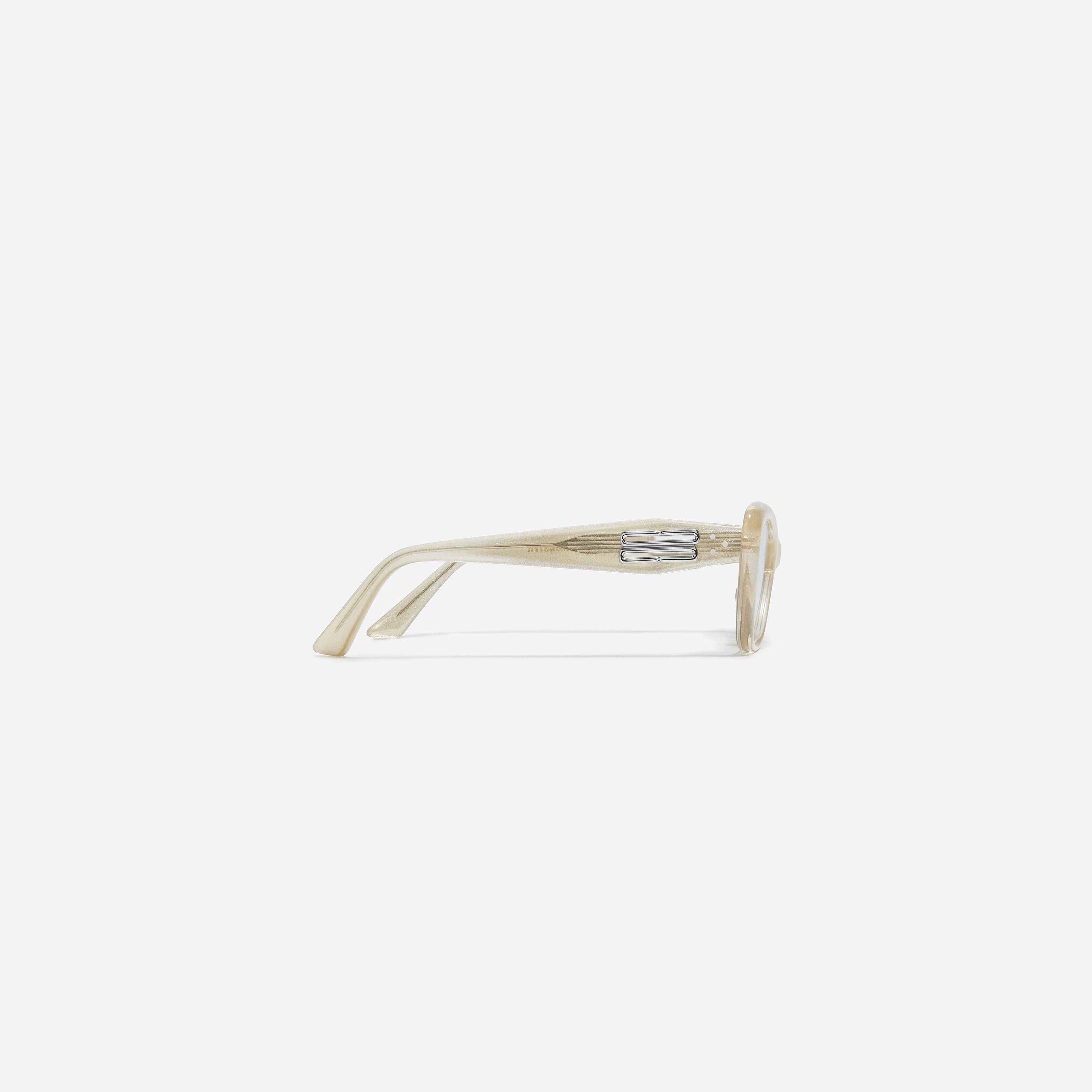 A detailed right view of Gentle Monster Amber GDC1 Gold Acetate framed Cat-eye sunglasses.