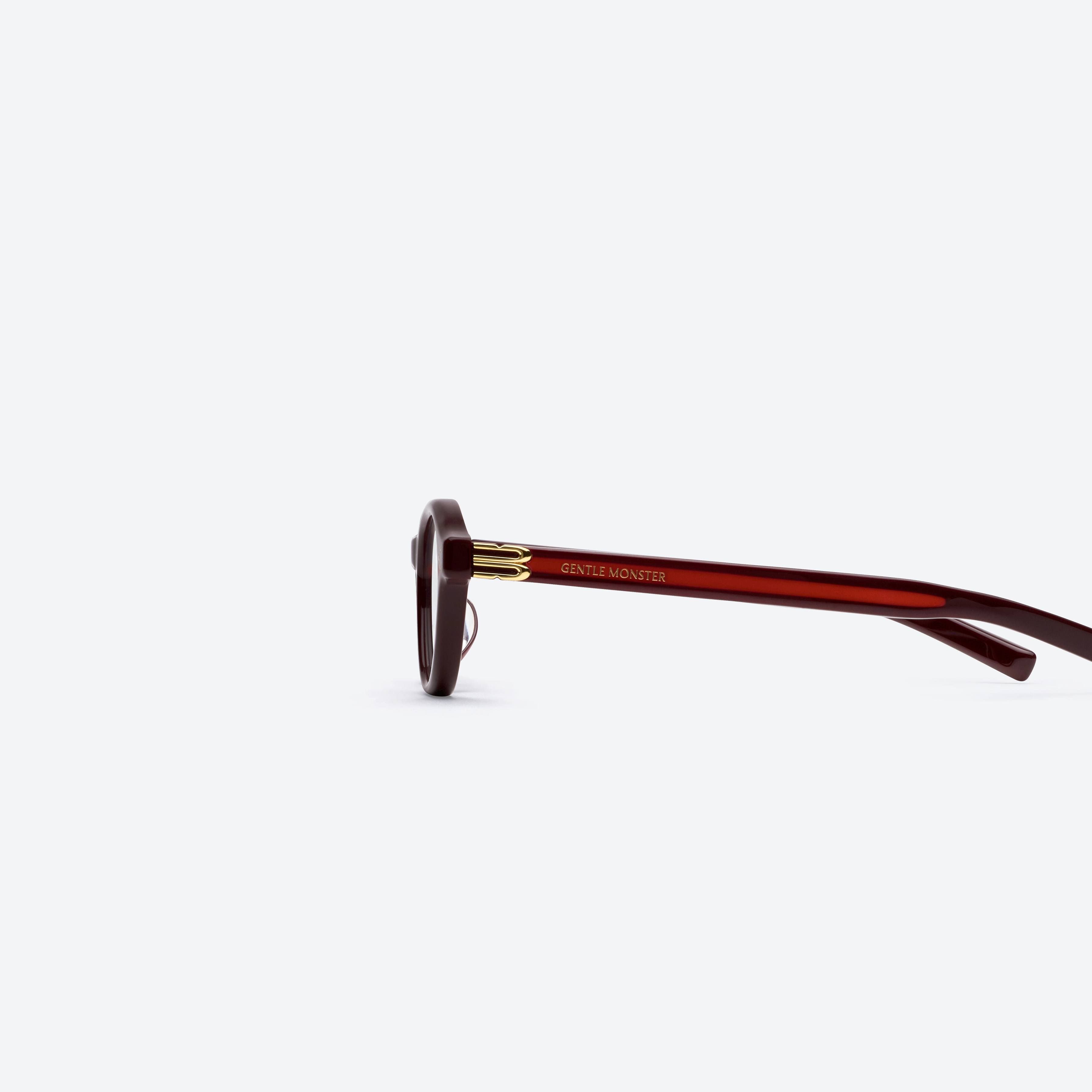 A detailed left view of Gentle Monster Lad R7 Red Acetate framed Round glasses.