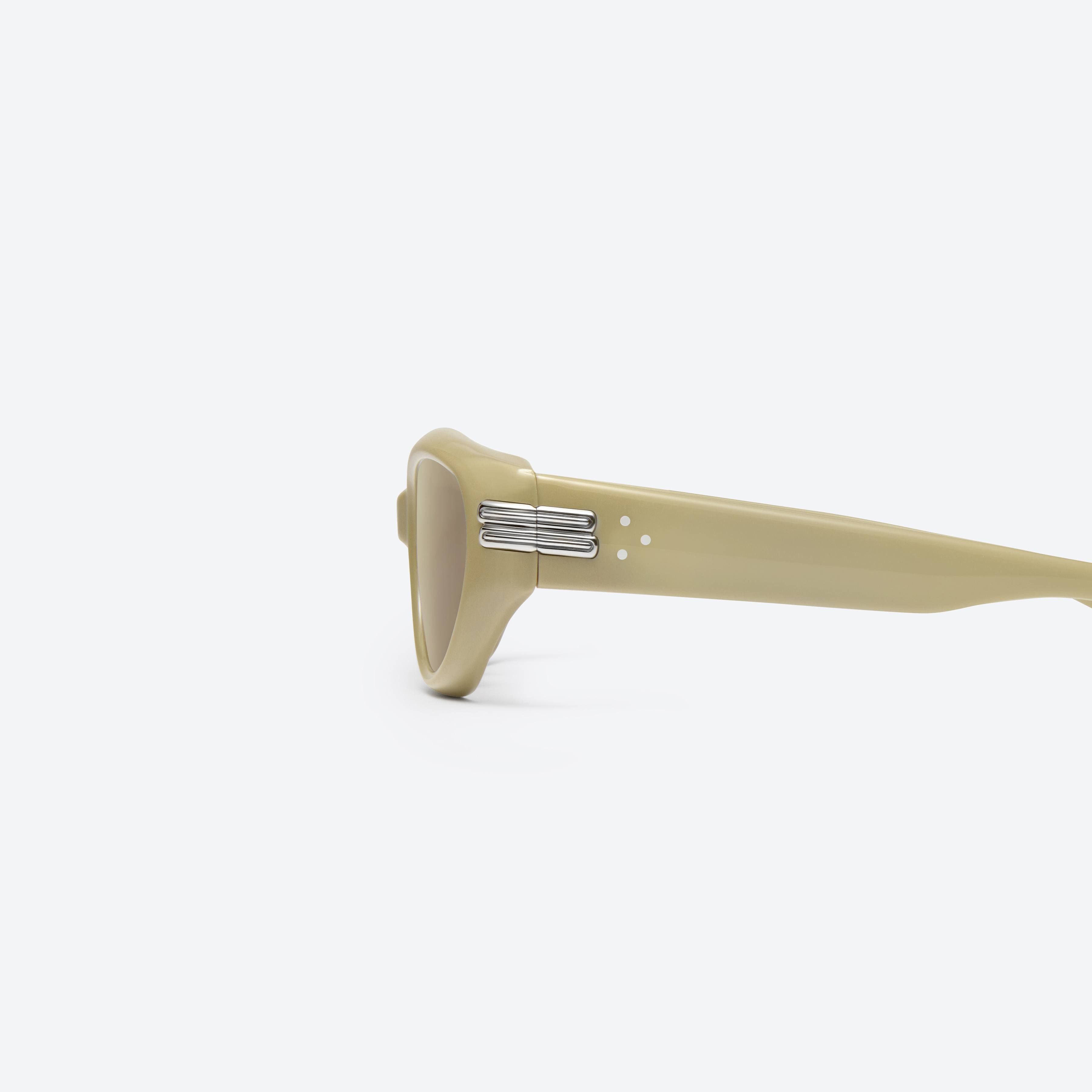 A detailed left view of Gentle Monster Kiko Y10 Yellow Acetate framed Wraparound sunglasses.