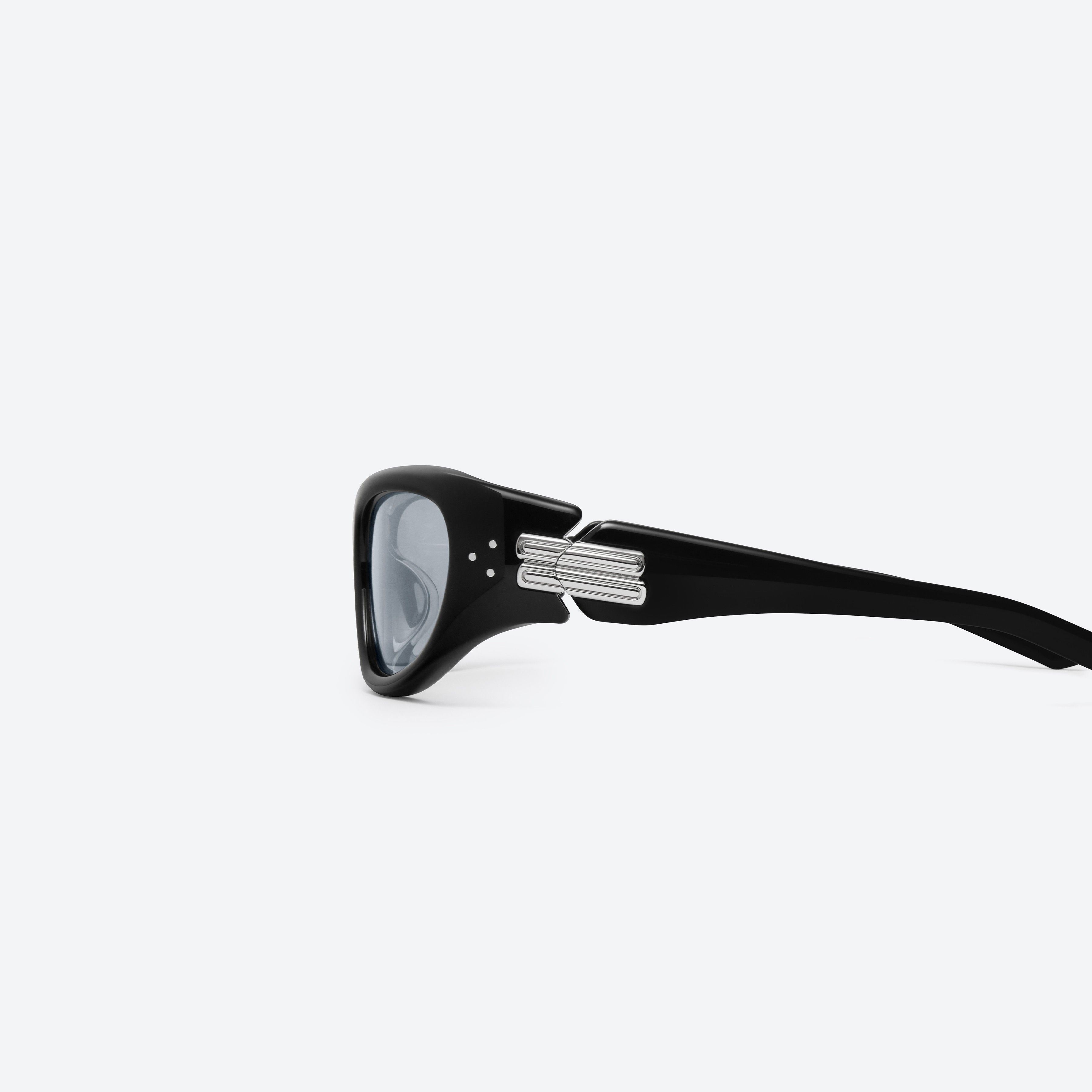 A detailed left view of Gentle Monster Memento 01(SM) Black Mixed framed Wraparound sunglasses.