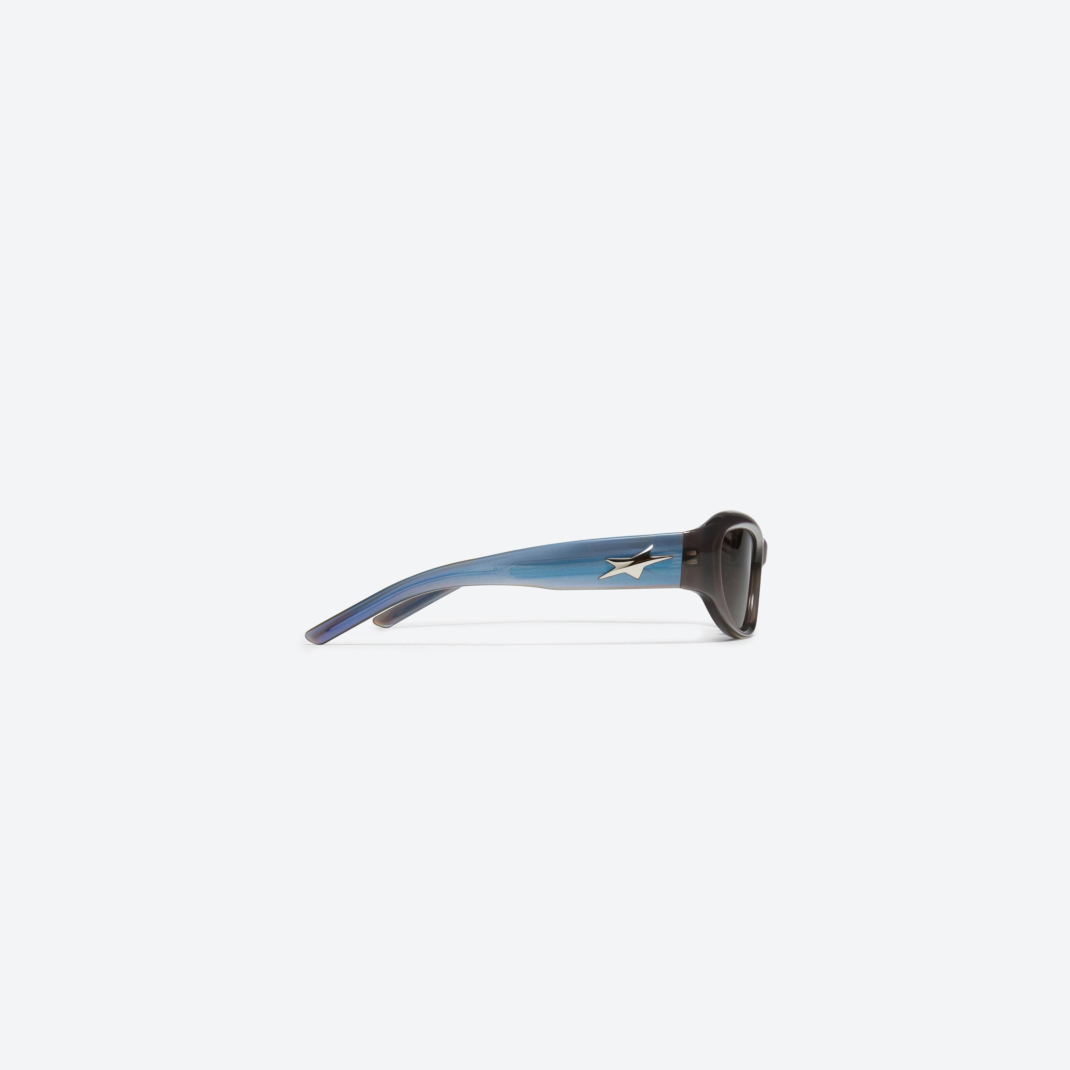 A detailed right view of Gentle Monster R.E.A.T BLC6 Blue Acetate framed Wraparound sunglasses.