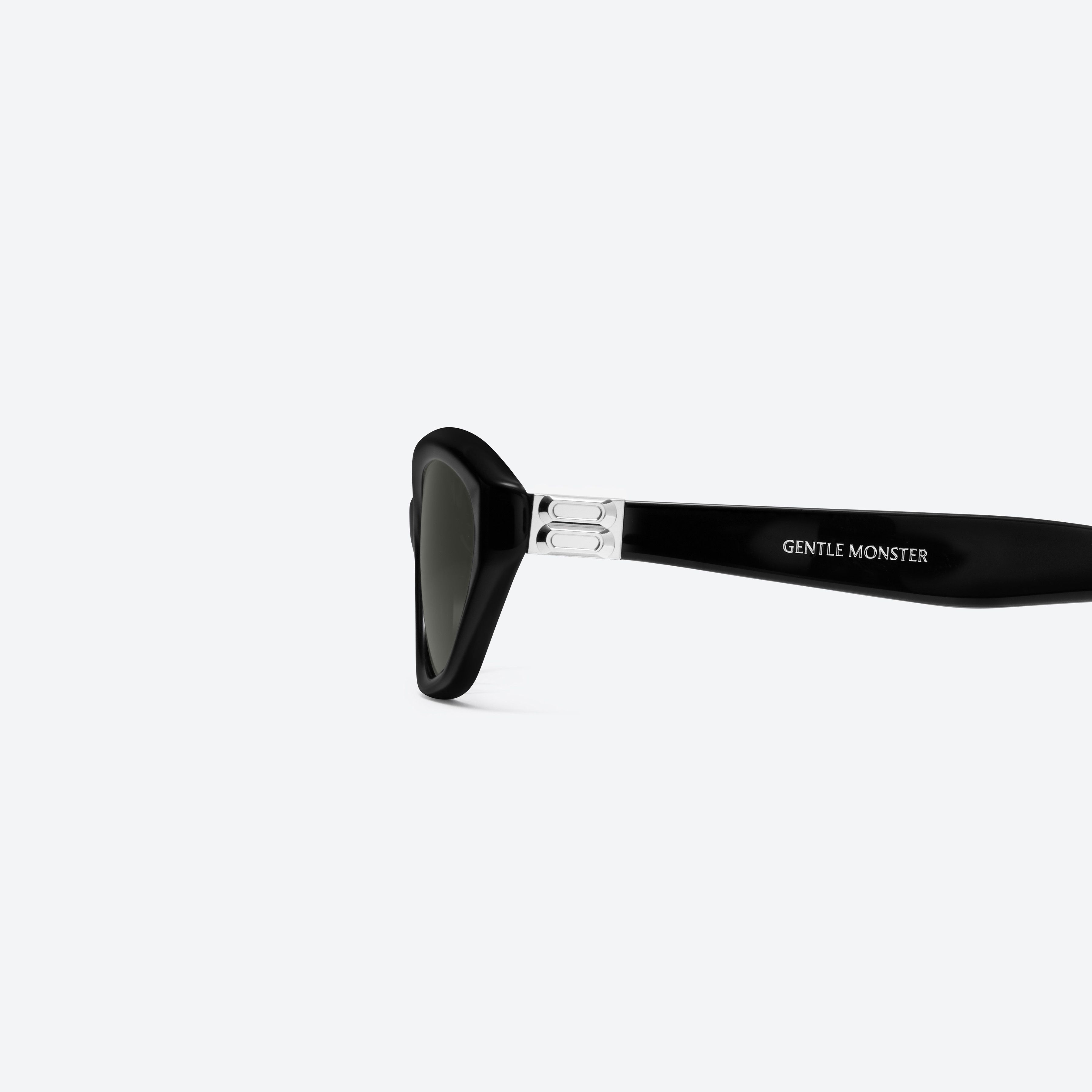 A detailed left view of Gentle Monster Lamda 01 Black Acetate framed Cat-eye sunglasses.