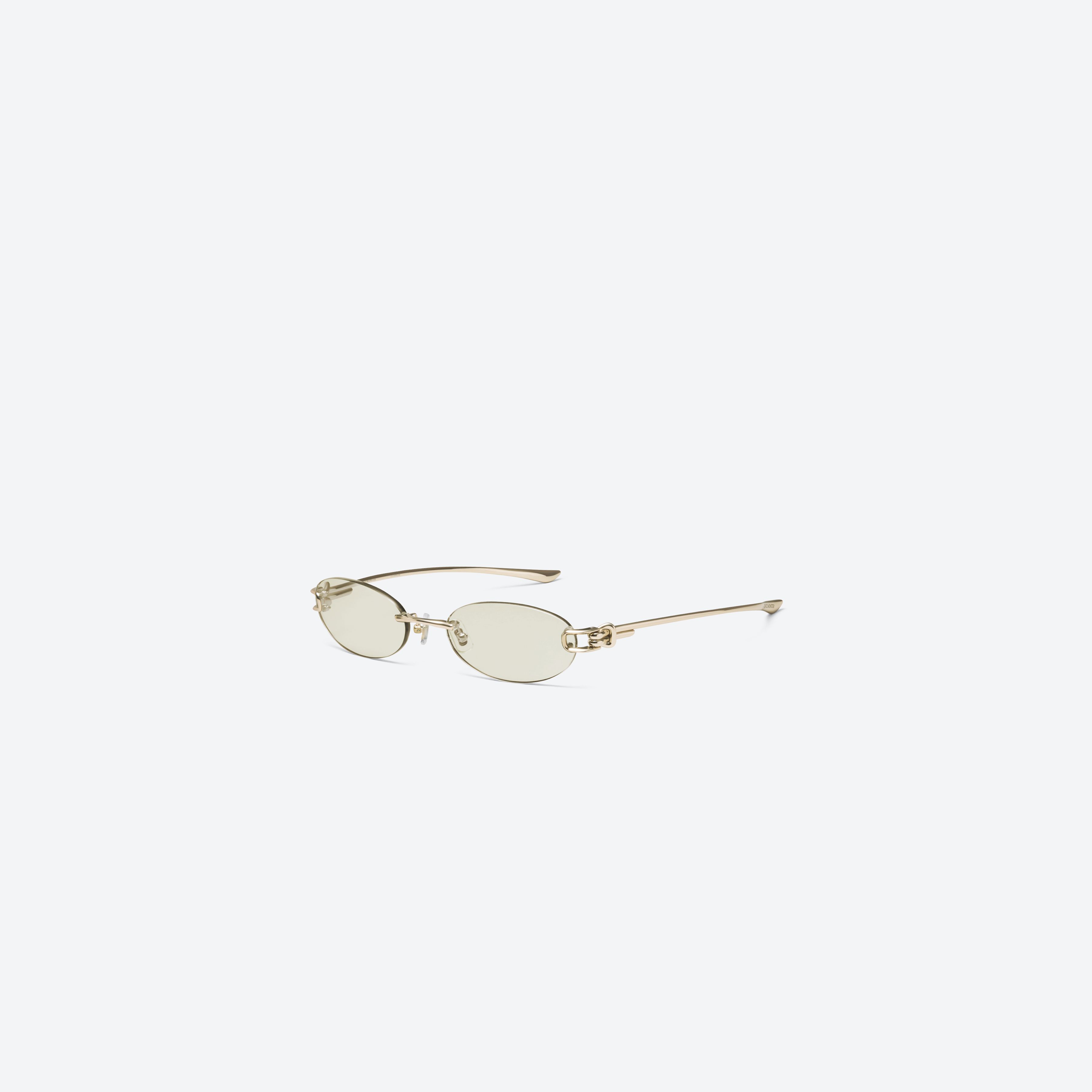 45-degree view of Gentle Monster Musubi 031 Gold Metal framed Oval sunglasses.