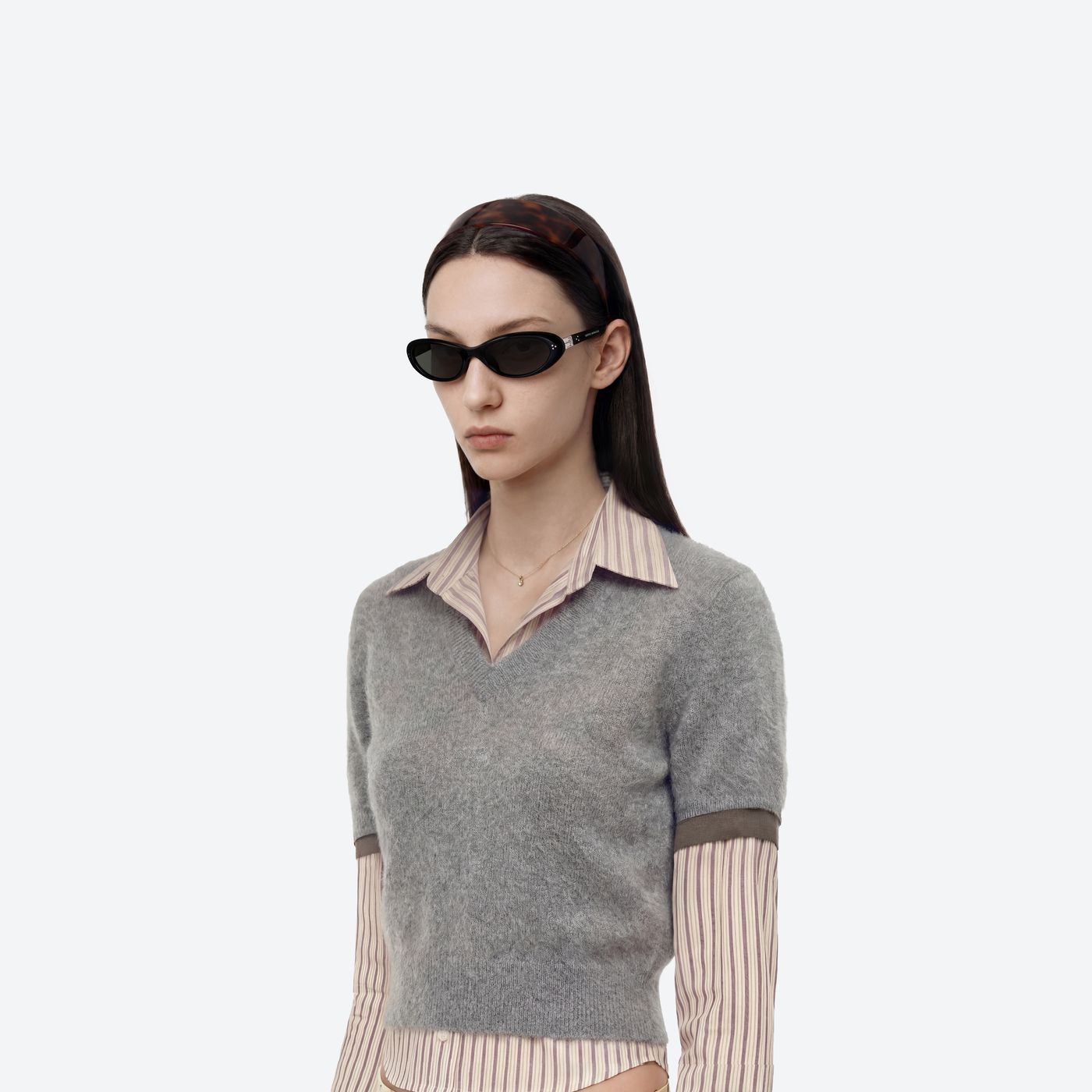 Model wearing the Cinnamon 01 Black Acetate framed Oval sunglasses.