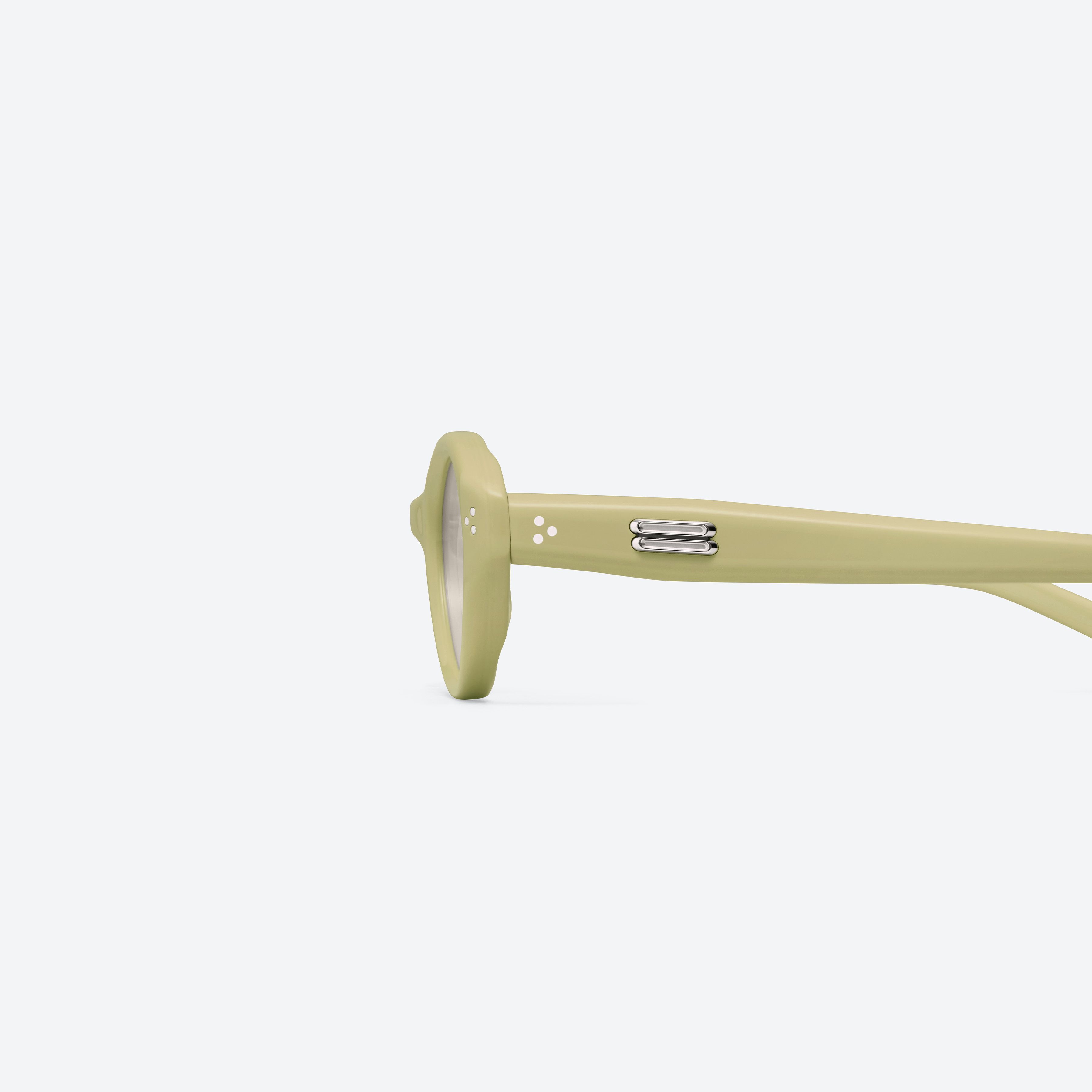 A detailed left view of Gentle Monster Cuscus Y11 Yellow Acetate framed Oval sunglasses.